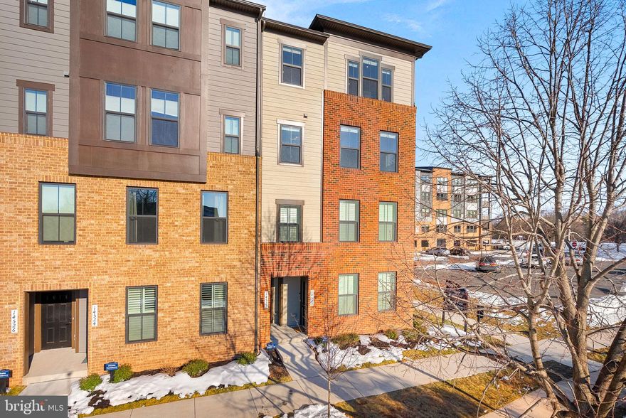 Welcome to this less-than-two-year-old end-unit condo at the highly sought-after Ellipse at Westfields—where style, comfort, and convenience meet. With no other end units currently available, this rare offering truly stands out and shows like a model home.

The main level features beautiful LVP flooring and elegant wood stairs, setting the tone for the thoughtfully designed interior. The stunning kitchen is the heart of the home, highlighted by an oversized quartz island, sleek stainless steel appliances, and abundant cabinetry—perfect for everyday living and entertaining alike. Just off the living room, enjoy direct access to a covered porch complete with a cozy gas fireplace, creating the ideal indoor-outdoor retreat year-round.

Upstairs, you’ll find three spacious bedrooms, two full baths, and a convenient laundry room with built-in cabinets. The luxurious primary suite offers a tray ceiling, a relaxing sitting area, and two large walk-in closets. The attached spa-inspired bath features separate vanities and a beautifully appointed Roman shower. Two additional bedrooms share a well-appointed full hall bath, providing comfort and flexibility for family or guests.

Nearly new, impeccably maintained, and move-in ready—this exceptional end unit is a rare opportunity you won’t want to miss.