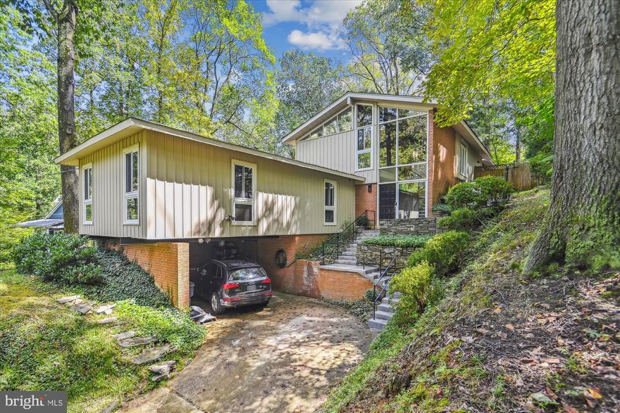 Welcome home to this *GORGEOUS* custom mid-century modern gem in sought-after Franklin Park! Fantastic opportunity to live in this inviting 3 BR/2.5 BA residence on 2 finished levels, where indoor and outdoor spaces seamlessly blend to create a comfortable and warm living experience.  As you step inside, you'll immerse yourself with the defining elements of this home; open-beamed vaulted ceilings, floor to ceiling windows, wood flooring, and an iconic foyer that creates an indoor/outdoor feel with an exposed brick wall and floating stone accents underneath the stairway. Natural light floods the entire foyer and living room area. Ascend to the upper level, with the floating staircase to the open-concept floor plan that effortlessly merges the living, dining, and kitchen areas and leads to a spectacular screened in porch and deck area. The home chef will enjoy cooking in the updated kitchen with a beamed vaulted ceiling overlooking the back porch area; an eat-in kitchen area; ample storage space; and granite countertops. The living and dining area are separated with a double wood burning brick fireplace and the kitchen overlooks the dining area with sliding doors to the outdoor porch area. The primary bedroom features an ensuite and luxury shower. There are two additional bedrooms, one that has space for a private office or exercise room; a full-size hall bathroom, and a large utility room with laundry and storage. If you love natural light and the connection with nature this home will not disappoint! Enjoy relaxing and entertaining in the private and serene back porch area that will quickly become your favorite spot. Chesterbrook, Longfellow, and McLean High School Pyramid!