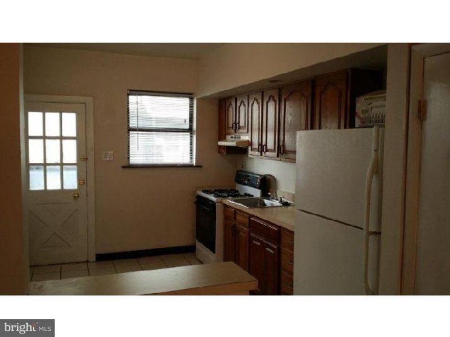 3 bedrooms, 1 bath house. Great location! Close to Broad St. 1st floor - refurbished hardwood floors in living room, open eik with oak cabinets and tiled floors, door to small yard. 2nd floor - newly renovated 3 piece bath with custom tiles. Front bedroom with bay windows, middle bedroom with 1 window and back with 1 window.  Hardwood floors throughout the 2nd floor. House is wired for cat 5 and cable ready. Unfinished basement.