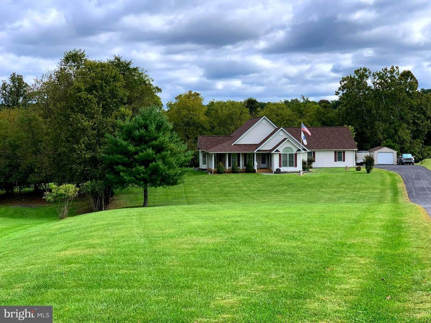 PROFESSIONAL PHOTOGRAPHS OF THE INTERIOR TO FOLLOW SOON. Located on 3+ beautiful acres in  Grant Acres Estate and bounded by mature trees and a small stream, this well built and maintained home is perfect for the growing family.  Conveniently situated between Martinsburg and Charles Town, with easy access to all commuter routes, you will be able to enjoy the country feel but still have easy access to shopping,etc. As you enter the home from the covered front porch you are greeted by an open ceramic foyer and solid wood staircase to the second floor. The open floor plan and cathdral ceilings continue the spacious feel of the home featuring a large living room, separate formal dining room an eat-in kitchen and a big laundry room with deep sink as well as an oversized (24X30) 2 car garage with automatic door openers. The kitchen has a walk-in pantry, granite counters, island with overhang for stools, a bump out nook for table and chairs, brand new laminate flooring, recessed lighting and stainless steel appliances which were installed in 2017 (with the exception of the microwave). The master bedroom boasts a cathedral ceiling and a walk-in closet. The master bath has a  jetted tub, separate shower and a new double bowl vanity. Then there are two more bedrooms and another full bath on the main level. All three main level bedrooms have laminate flooring, the foyer and hallway to the garage are done in ceramic flooring. There is no carpeting anywhere in the main level of the home. Upstairs is a fourth bedroom and more semi- fininished space for potential expansion which makes for a great deal of storage space. This energy efficient home is constructed with 2X6 exterior walls, double hung windows, and a propane gas back up to the electric heat pump. (The current owners have only filled the underground propane tank once in the last 5 years). The roof was replaced with new architectural shingles in 2017 and a new water softener/filtration system was installed in 2018. You will love the convenience of the central vacuum system as well as the highspeed cable internet connection for working from home. Watch the deer and turkey from the covered back porch while enjoying your morning coffee and then take a walk out to your fenced garden for fresh vegetables or to pick blueberries and blackberries. You will also have use of the Grant Acres Estate recreational lot with private Opequon Creek access for fising, canoeing, etc and a covered picnic area for get-togethers with the family. The home will convey with a one year home warranty paid by the Seller at settlement. This little piece of heaven will not last long, call now to make your appointment to view the property now before it is gone.