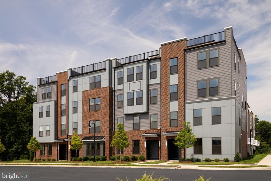 **Up to 20K IN FLEX CASH WITH USE OF APPROVED LENDER AND TITLE! Lower your price, cover your closing costs, or buy your rate down** 
Move-in ready! Step inside the Clarendon, where thoughtful design and stylish finishes come together in every room. Enter through the welcoming front door or enjoy the convenience of access through the private rear garage—both leading into the main living level. At the heart of the home, the gourmet kitchen shines with gray cabinetry accented by elegant gold hardware, complemented by designer pendant lights over the oversized 12' island. An upgraded induction cooktop and walk-in pantry complete this chef-ready space. Just beyond, the dining room flows seamlessly into a spacious great room that opens to a covered lanai, ideal for indoor-outdoor living. Upstairs, the primary suite offers a private retreat with an expansive walk-in closet and a spa-inspired bath featuring gray cabinetry, gold fixtures, and a ceramic-tiled walk-in shower with seat. Two generously sized secondary bedrooms share a full hall bath with crisp white cabinetry, upgraded ceramic tile, and modern black hardware. A full-size washer and dryer are conveniently located on this level. Continue up to the impressive rooftop terrace to take in sweeping views of One Loudoun Central Park and Town Center—the perfect spot for morning coffee or evening entertaining.