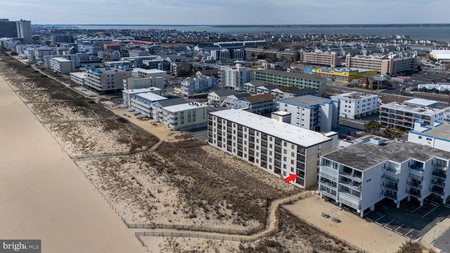 Slice of heaven 2nd floor two-bedroom condo (end) unit with balcony just above beach dunes. End unit makes it wonderfully bright. Reserved parking space right at bottom of quick flight of stairs, which are also very short path directly onto beach.  All shopping needs very, very short walk across Coastal Highway.