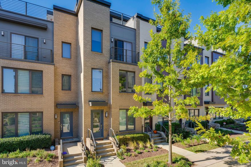 Parking: 2 free guest parking passes are available. One for the street and one for the garage that is shared with the office building a block away. Welcome to this bright, spacious, and contemporary townhouse in the highly desirable Montgomery Row Neighborhood  in Bethesda. Built by EYA  in 2018, this LEED Green certified townhome is a contemporary showpiece. The owners have made considerable updates and improvements since purchasing from the developer including a Thermador gas range, touch less faucet, stylish backsplash, new flooring on every level, new water heater (2025), New Roof (2023) and elevated cabinets and waterfall quartz countertops. ALL of the bathrooms have also been updated and improved upon, and all closets include custom Elfa closet systems. 

The first floor has ample storage space and a two-car garage. The main level's  large windows and high ceilings draw lots of natural light into the open floor plan. The living room is cozy and bright and the dining room is spacious enough to comfortably entertain. The powder room off the kitchen features a custom marble vanity and elegant marble floor tiles. The gourmet chef's kitchen includes a large pantry and direct access to the deck. The upstairs bedroom level features a large primary suite oasis with a walk-in closet, automated double shade, and an en-suite bath. The guest bedroom, which can serve as a home office, includes another  en-suite full bath.  Rounding out the bedroom level is a full-size LG washer and dryer located in the hall closet. The top floor features another bedroom and full bath with a large recreation space perfect for a home office, home theater, or workout studio. The private rooftop deck is a showstopper with gorgeous views of the neighborhood.  

The apex of comfortable and convenient living, this home perfectly positions the buyer to take advantage of all Bethesda has to offer.  Located within walking distance to Westfield Montgomery Mall,  Wildwood Shopping Center, Suburban Medical Center and less than a 10min drive from Downtown Bethesda. Shopping trips and nights out are made as convenient as possible. This location is also commuter friendly with easy access to I-270 and I-495. The community is very  pedestrian-friendly with wide walking paths connecting the playground, promenade, and community park.