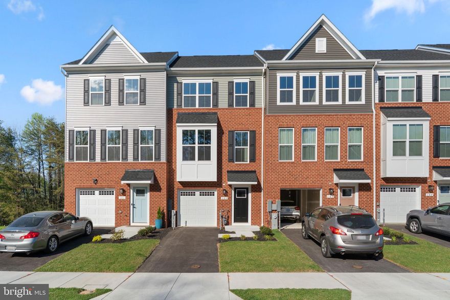 Welcome to The Highlands. This brand-new construction townhome has never been lived in and offers modern finishes with thoughtfully designed living spaces. Enjoy luxury vinyl plank flooring on every level—no carpet! The fully finished entry level features a one-car garage and a versatile recreation room, perfect for a home office, gym, or additional living space. The main level boasts a bright and open floor plan with a spacious family room and dining area that flows seamlessly into the upgraded kitchen, complete with a large island. A convenient half bath is also located on this level. Step outside onto the deck overlooking the backyard and wooded area, creating a peaceful setting to relax. Upstairs, you’ll find three generously sized bedrooms and two full bathrooms, including a comfortable primary suite designed for everyday retreat. Enjoy the convenience of community amenities just steps away, including an outdoor pool and playground. Perfect for the warmer months ahead. Ideally situated with easy access to Route 10, Route 100, and I-97, offering a convenient commute to Baltimore, Annapolis, D.C., and Fort Meade. Outdoor enthusiasts will love nearby Kinder Farm Park, Lake Waterford Park, and the scenic B&A Trail for biking and recreation. Shopping, dining, and daily essentials are all within close reach. Builder warranties included. Mortgage savings may be available for buyers of this listing. Don’t miss your opportunity—this one won’t last long!