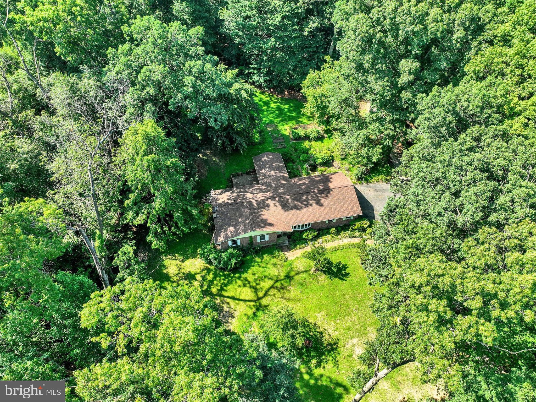 Tucked away on 3.5 private acres, this brick rancher offers the rare opportunity to create your dream home in the Hereford Zone. 5 bedrooms, 3 full baths, and an expansive layout with tons of living space—perfect for entertaining or spreading out. Fully finished basement with a full bath makes a great recreation space. Enjoy the beauty of nature from the screened in porch or cultivate your own garden space in the back yard. Located just 5 minutes from I-83, you'll enjoy the best of both worlds: serene privacy and an easy commute. A finished two-story outbuilding is perfect for any hobby with it's own screened in porch. Perfect home for the buyer that wants to create their own oasis!