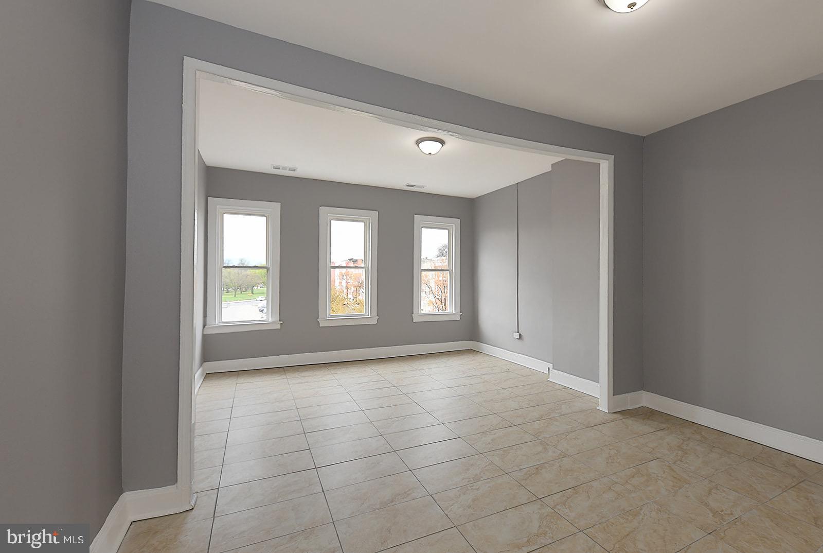 Welcome to Unit 3—a spacious, studio-style apartment in the heart of Baltimore’s historic Union Square neighborhood. This oversized studio offers impressive functionality, with enough room to comfortably create separate zones for sleeping, working, and dining—all in one open, sunlit layout.
Large windows bring in plenty of natural light, highlighting the clean tile flooring that’s perfect for one statement area rug or even a decorative room divider to personalize your setup. The tucked-away kitchen features a gas stove, above-range microwave, and just the right amount of separation from the main living area.
The bathroom includes a walk-in shower with modern finishes, and the layout of the unit offers plenty of space to live and work comfortably.
Located just minutes from downtown Baltimore, Unit 3 is within walking distance to Union Square Park, public transit, local coffee shops, and more. Enjoy the charm of a historic neighborhood with easy access to city life. Book your tour today.