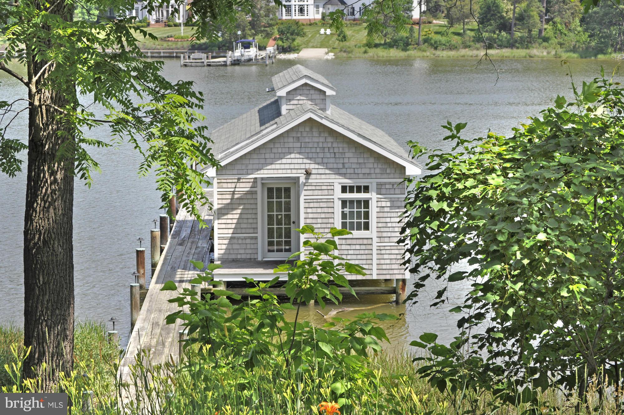 Sited on over 2 acres with 120' of water frontage along Peach Blossom Creek, this cottage-style residence is minutes from downtown Easton. Main residence, boat house & Dock w. electricity, separate guesthouse and garage. Gourmet kitchen, 2 fireplaces, open floor plan, updated bathrooms, flagstone patio with panoramic views, all perfect for enjoying the charms of Easton