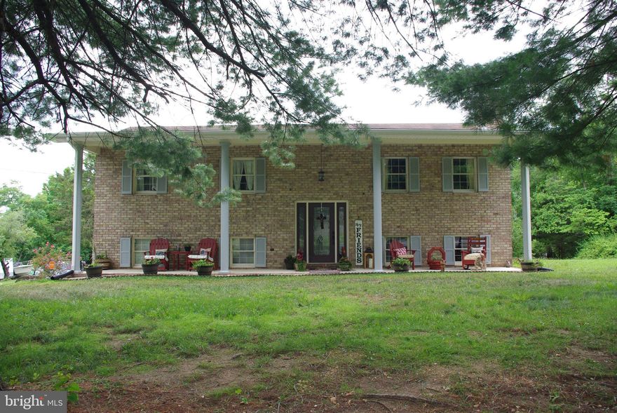 Welcome to this charming split foyer home nestled on 1.31 acres of serene land. This property boasts 4 spacious bedrooms and 3 bathrooms, offering ample space for your family. The basement features a fully equipped in-law suite with a full kitchen, perfect for guests or extended family. The 2-car garage is fully heated and cooled, providing comfort year-round. The home also features new heat pump systems for energy efficiency and an asphalt driveway for easy access. The property is adorned with mature shade trees, enhancing its natural beauty. You'll love the covered front concrete porch that spans the width of the house, ideal for relaxing and enjoying the peaceful surroundings. Located close to Martinsburg, you'll have convenient access to all the city has to offer while still being off the beaten path in a very quiet location where you can enjoy the sounds of wildlife from your front porch. This home combines modern comforts with a touch of nature, making it the perfect retreat