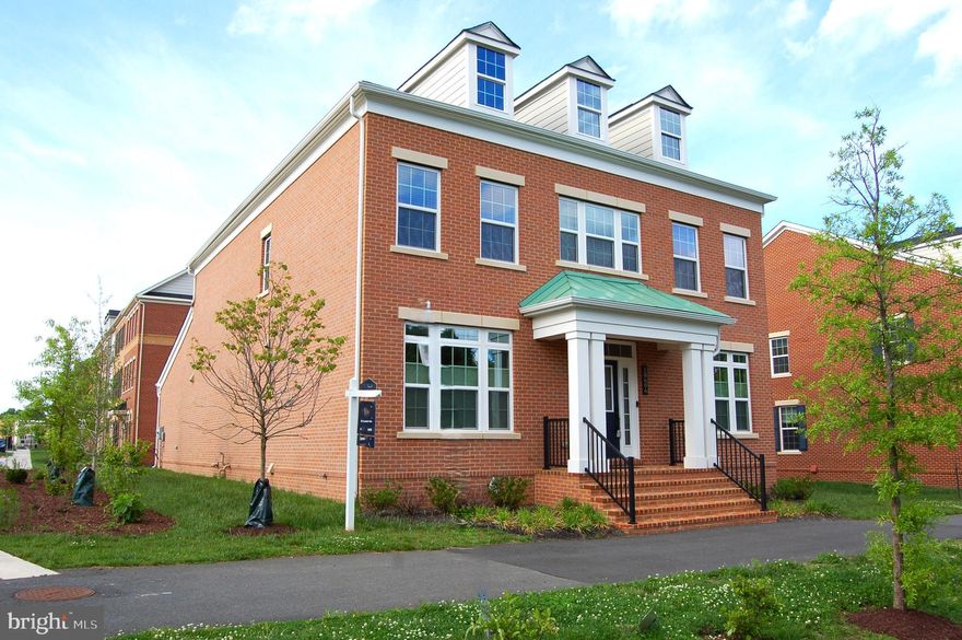 The Towns of Boulevard VI is Fairfax City's Newest City-inspired community showcasing 'walkabilty' to surrounding retail, dining, parks, and shops! Designed to complement the architecture of Historic Fairfax, this stately  ALL-BRICK, Center Hall Colonial w/Open Floor Plan is one of the EXCLUSIVE number of Single Family Homes built in the community among Luxury townhomes and Condos!  1 year New! MOVE-IN READY with $25K in premium Builder options, $93K in architectural UPGRADES PLUS NEW WINDOW TREATMENTS throughout! ALL Bedrooms on the Upper 2 levels are SUITES w/private baths! The Primary Bedroom has TWO walk in closets! Primary Bath includes soaking tub, LARGE walk-in shower w/bench seat in frameless glass enclosure, 2 separate vanities, an enclosed water closet, and the 2nd WALK-IN CLOSET!  Open Floor-Plan with 9' ceilings, Formal Dining Room WITH Butlers Pantry! Other Features include  a MAIN LEVEL BEDROOM & FULL BATH off the Foyer with easy access from Family Rm and covered  Porch for those with limited mobility.   Gourmet Kitchen features oversized Island w/quartz counters & full-length breakfast bar, Pendant and recessed lighting, GE Profile SS appliances, Gas Cooktop w/range hood, double wall oven w/ built-in microwave AND electric convection oven, SxS Fridge with through door ice/water, TWO Walk-In Pantries! Mud Room off kitchen with built-in coat rack/bench/shoe alcove provides Garage access to two car garage w/220V EV charging station! SMART devices include thermostats/doorbell cam/WiFi signal repeaters on ALL 4 Levels, remote main water shutoff,  motion/smoke/carbon monoxide detectors, & alarm system.  Separate 8x5 Laundry ROOM off U1 hallway with cabinet and utility sink!  The U2 loft bedroom suite includes access to high-efficiency GAS FURNACE servicing the Upper 2 levels..  The basement features a SPACIOUS Rec Room with walk-behind BAR featuring granite counters, cabinetry w/ under-cabinet lighting, wet bar, dishwasher, and mini fridge! Full bath off rec room, and 6th BR with window-well EGRESS window (1 of 2 egress window wells in basement), don't miss the unfinished BONUS ROOM next to the stairs, it's excellent storage, but would also make a great media or exercise room.  Less than 1 mile walk to Fairfax City Historic District Events, Restaurants, Library, Shops, and Offices. Metro Bus stops at community,  Mins to I-66 and Vienna Metro!