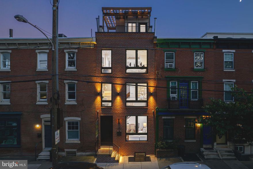 Step inside 2403 Grays Ferry Avenue, where the stresses of the day instantly melt away. As you walk through the front door, you’ll find yourself in a spacious, light-filled living room, where natural light streams through large windows, creating a warm and welcoming atmosphere. Picture yourself unwinding here, listening to music on your built-in speakers, whether it’s for a cozy night in or entertaining friends. The open layout flows effortlessly from the living room into the dining area—no barriers, no clutter, just seamless transitions that make everyday life a breeze.

Moving beyond the dining area, you pass the beautifully designed quarter-turn staircase and convenient half bathroom, leading you to your show-stopping kitchen. Sleek and modern, the kitchen dazzles with custom European cabinetry, offering abundant storage to keep everything neatly tucked away. High-end Bosch and JennAir appliances make cooking an absolute pleasure. Whether you’re preparing a gourmet meal or grabbing a quick snack from the pantry, everything is within easy reach. The stunning quartz countertops provide ample space for prepping, and when you’re ready to relax, open the French doors to your private deck—perfect for your morning coffee or a peaceful evening drink in your own outdoor sanctuary.

Upstairs, the ease of living continues with two generously sized guest bedrooms, each with its own en suite bathroom. No more morning traffic jams—every guest or family member has their own private space. These bedrooms are beautifully appointed with bespoke tile work, custom lighting, and modern finishes that bring a touch of luxury to everyday routines. The front bedroom offers serene views of the green space at Naval Square, while the rear bedroom overlooks the iconic Saint Albans Place. Need fresh towels or linens? No problem—the convenient hallway closet is right where you need it, without the hassle of heading downstairs.

The third floor is dedicated to the primary suite, where you’ll fall in love. The space is expansive, with room for a king-sized bed and a cozy seating area for reading or watching TV. The walk-through closet awaits your personal touch to make it truly your own. In the primary bath, luxury abounds—imagine stepping onto the heated oversized tile floors on a chilly morning or indulging in the double rain shower as the warmth soothes you after a long day. The heated shower bench adds another layer of comfort, and yes, there’s even a window in the shower with a view of charming Saint Albans Place.

Heading up one more level, you’ll find the pilot house, complete with a wet bar that makes rooftop entertaining easy and convenient. Sunlight streams in from the skylight, brightening each floor below. When you reach the roof deck, prepare to be wowed by the breathtaking 360° views of the city. Whether you’re hosting a sunset gathering under the custom pergola or enjoying some downtime with your favorite playlist on the built-in speakers, this space is designed to elevate your life with ease and style.

Don’t forget about the finished basement, offering versatility to suit your lifestyle—whether it’s a home gym, playroom, extra bedroom, or just extra storage, it’s all here. With heated floors, the basement is comfortable year-round, making it a perfect extension of your living space.

To top it all off, this home comes with the benefit of a 10-year tax abatement, making it a smart investment for the future. Situated in the coveted Marian Anderson school catchment and steps away from beloved local spots like Ilatta, Sidecar Bar & Grill, Igloo, Grace Tavern, Ants Pants Café, and Heirloom Market, this home offers the ultimate combination of comfort, convenience, and modern luxury. Whether you’re a busy professional or growing family, 2403 Grays Ferry Avenue has been thoughtfully outfitted with upgrades and features designed to make everyday living effortless.

Come see for yourself how easy and enjoyable l