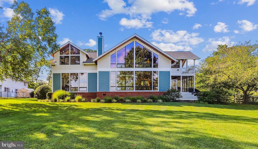 Absolutely stunning post and beam waterfront property located at the entrance to Cadle Creek, just off the Rhode River and the Bay.  This meticulously maintained contemporary home is more than just a waterfront home with breathtaking views, it's a sanctuary that offers a getaway from a busy life.  A fully fenced yard of 1.78 acres contains several beautiful garden areas to admire, as well as large grassy areas to play and entertain.  A flagstone walkway leads you to a serene courtyard at the front entry and dual mahogany glass doors and an 8' transom window gives a sneak peak of the waterview.  Once inside you are greeted by the warm Brazilian cherry hardwood floors that flow into a 2 story living room and a slate stone fireplace with triple mantels.   Beyond is a wall of glass giving an unencumbered view of the rear of the property and Cadle Creek from the living room, dining area, and kitchen.  A spacious gourmet kitchen features everything you need to whip up a culinary masterpiece, or entertain a large group of friends.  Dual sinks,  Sub-Zero refrigerator, warming drawer,  wine refrigerator, and a separate Scottsman ice maker and more make it a breeze.  When the weather is nice you can escape out the side door into a huge screened in porch area to enjoy a meal or drinks.  The main level primary suite has triple floor to ceiling windows to enjoy the same dramatic views from the moment you awake till sundown.   All three full bathrooms feature heated tile floors so you don't have to sacrifice comfort on chilly days.   Upstairs there is a bonus family room or seating area in the loft with it's own wet bar.  A second primary/guest suite has its own full bathroom and views of the Creek.  The third bedroom has sweeping views of the front of the property and gorgeous exposed cedar beams and ceiling.  Between the 3rd and 4th bedrooms is a connected bath and a Finnleo sauna to de-stress after a long day or workout.  This last bedroom just off the loft area is wrapped in windows and offers panoramic views of front and back from inside, or out on the large covered balcony.  Back on the main level is the laundry area with loads of cabinet space and a fixed sink.  A bonus room off the laundry/garage hallway could be a great hobby, office, or workout space with it's own separate entrance.  The oversized 3 car garage has room for all your vehicle and toys!  Stairs from the garage lead above to unfinished space ready for you to make your own.   At the backside of the property is your gateway to all the fun of a waterfront lifestyle.  48' of waterfront is draped with natural grasses and a wide pier that sits up high to escape the tides yet provide 6'MLW depth.  There's a 20k lift and power and water supply to the end of the dock and even space to put a couple of chairs and watch the boats go by.  Don't hesitate to check out this stunning property that only comes by once in a lifetime!