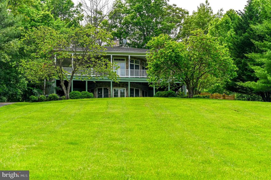 A Rare Deepwater Potomac Riverfront Retreat
Discover a truly unique offering—this custom-built home rests on a coveted deepwater section of the Potomac River, boasting over 200 feet of direct river frontage along a scenic 12-mile stretch. Nestled on a two-tiered lot, the property provides not only breathtaking views and tranquil surroundings, but also rare private access to the river—perfect for boating, fishing, and water recreation.
The home features a full 360-degree wraparound porch and offers 2,775 finished square feet of thoughtfully designed living space. Inside, you’ll find soaring 10-foot ceilings, true Maple hardwood flooring, custom cabinetry, crown molding, wainscoting, chair rail detailing, a tile backsplash, and a striking stone-surround wood-burning fireplace.
The main level is filled with natural light and includes a spacious living room with French doors opening to the porch, a formal dining room, and a well-appointed kitchen with stainless steel appliances and beautiful custom cabinetry. The primary suite features a walk-in closet, oversized bath, and private porch access. A second bedroom and full bath complete the main level.
The lower level offers high ceilings, new carpet, a large family room (with pool table included), an en suite bedroom, a half bath/laundry room with water treatment system, and two additional rooms ideal for guests, a home office, or hobby space. A whole-house generator ensures comfort during inclement weather.
Outdoors, you'll find a detached 2.5-bay garage, a 2-car carport, and multiple outbuildings, including two “coverall” structures. The lower portion of the lot is fully equipped with electric and water hookups, an RV connection, a pavilion, and a deck with stairs leading to the water. The property also conveys a floating dock and the on-site camper/RV.
This is a rare opportunity to own a high-quality custom home with unmatched river access and amenities—schedule your private tour today!