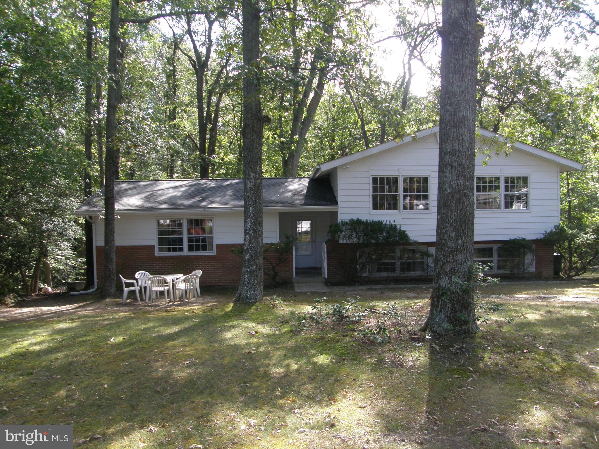 Solid very spacious 3,000 square feet split level with large rooms that was originally used by a church for parsonage and church office. Upon entry there are two entrances: one for office and other for residence. They are internally connected. Great for Home Office or potentially Mother-in-Law Apartment since it is separated from other residence living and bedrooms. Open entrance foyer with slate tile that leads to lower level and upper level. Many components upgraded along the way: kitchen (2010/2011), appliances, septic (tank and fields), hot water boiler, hot water tank, bath vanities and fixtures, roof (2012), front door, storm doors, sliding doors (2010). Living area is open to foyer with half wall from kitchen to dining/living. Solid wood interior replacement doors on site. Wood stove in fireplace with metal flue cleaned in 2024. Move in and enjoy. Perfect for a large family with great potential to create your own dream home. Lots of space and large rooms with lots to work with! All furniture conveys. Seller desires a "as is" sale with all buyers requested inspections as desired. Vacant. Adjoins large single waterfront parcel. Walk to Town Creek Elementary and County Park with new marble court, tennis, and playground which adjoins Town Creek Pool (memberships available). Great location in established community with close proximity to services, shopping and employment. Quiet dead end street.