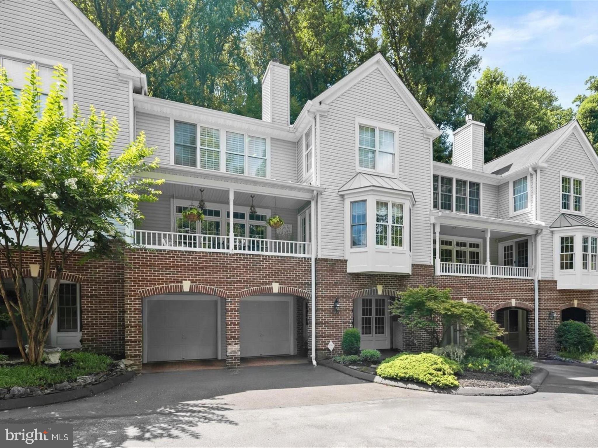 Discover 1007 Lillies Lane, a luxury townhome in the sought-after Rivers Ridge community, perfectly positioned to overlook the scenic Patapsco River. Steeped in the historic charm of Historic Oella and Ellicott City, this exquisite home is framed by lush foliage and extensive hardscaping, offering a serene and private retreat just moments from trails, shops, and restaurants. Inside, this designer’s residence showcases rich hardwood floors, classic moldings, and custom built-ins that lend character and warmth throughout. The entry-level welcomes you with a private office framed by a sun-drenched bay window, a versatile bonus room, a powder room, and access to the attached two-car garage. Upstairs, the elegant living and dining rooms are bathed in natural light, with the living room anchored by a cozy fireplace and a custom wine nook with built-ins. The chef’s eat-in kitchen is the heart of the home, featuring sleek stainless steel appliances, soft-close cabinetry, decorative backsplash, granite countertops, a walk-in pantry, bench seating with views of the lush landscape, and a casual dining area with direct access to the deck and lower patio. A charming sitting room with built-in shelving, bay window, private balcony access, and an additional powder room completes this level. On the top floor, the spacious primary suite impresses with soaring ceilings, a walk-in closet plus a second closet, and an en-suite bath with dual vanities, a skylight, and a glass-enclosed shower. Two additional bedrooms, each with vaulted ceilings, a full bath, and a convenient laundry area round out this exceptional home.