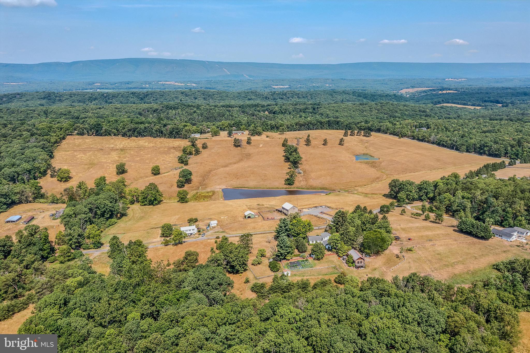 50.884 UNRESTRICTED ACRES - Situated in the Southern Morgan County. This land has had lots of tender loving care. New fencing surrounds the property with a barn on the far corner. Two ponds that have been cleaned. The entire parcel is very usable and the hay is cut. Bring your livestock and or build your dream home here. This parcel fronts on two state maintained roads so it has great access. Enjoying riding your UTV, fishing in the pond or just relaxing in a beautiful setting. Welcome to Wild Wonderful West Virginia!
This property does not include the two, 2 acre parcels on the corner of Pine Grove and Troy.