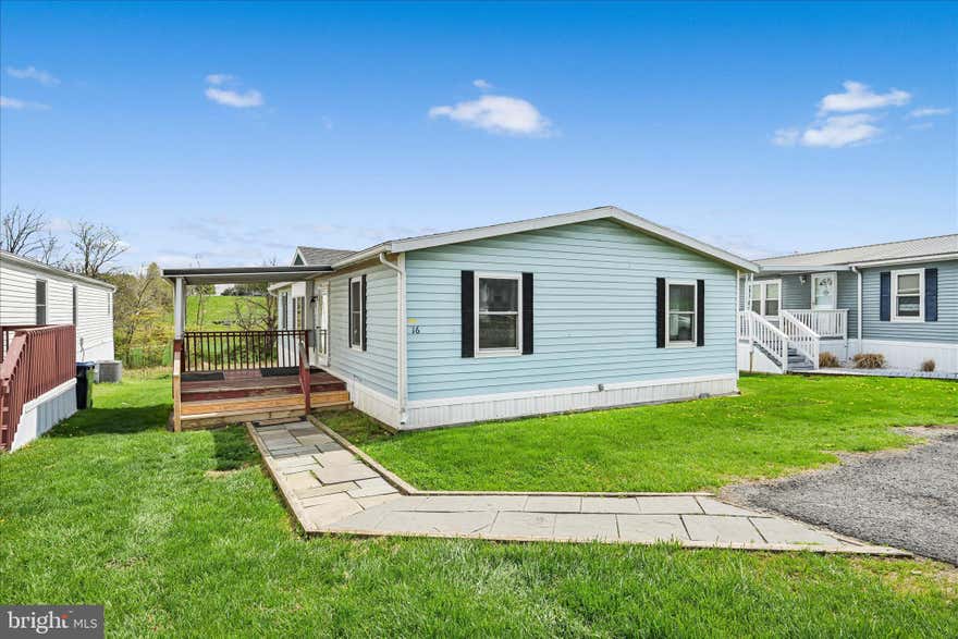 Come check out the farmland views from this double wide in a peaceful little community! All the major things have been done for you in the past few years, including a new roof in 2023 and new HVAC in 2020, as well as a brand-new back deck. With a little love, this spacious home could be exactly what you've been looking for. The primary suite is a private escape, as it's separated from the other bedrooms and features a walk-in closet as well as a full bathroom with double vanity. The living room area has a spacious and open feel with new LVP flooring and vaulted ceilings. Two additional bedrooms and a full bathroom with bathtub round out the right side of the home. The kitchen and dining area have an open flow, with a conveniently located laundry room to the left of the kitchen. Conveniently located near 222 and Route 30, as well as the famous Shady Maple Smorgasbord.
