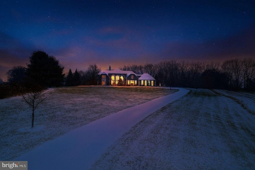 A residence of rare distinction, this one-of-a-kind architectural masterpiece offers over 5,200 sq. ft. of refined living space plus an additional 2,200 sq. ft. luxury finished walkout level on 13.5 Acres! Beyond the covered entry, guests are welcomed into a breathtaking 22-foot vaulted great room and formal dining area, framed by a dramatic wall of windows, rich hardwood floors, a wood-burning fireplace, and a sophisticated resort poolscape. The first-floor Primary Wing is a true sanctuary, featuring a gracious sitting room, elegant library with fireplace,offering the ultimate blend of comfort and privacy. At the heart of the home, the gourmet kitchen showcases premium finishes and opens seamlessly to the warm and inviting family room with gas fireplace and direct access to the custom-designed patio, inground pool with waterfall, and outdoor entertaining areas. The second level provides exceptional accommodations with three private bedroom suites, each with its own bath, along with a luxurious guest suite ideal for extended stays. The spectacular walkout lower level elevates the home’s entertainment appeal with a handsome sit-down wet bar, an expansive game room, offering endless recreation for family and guests. Outdoors, this estate transcends tennis/basketball court and expansive patio, additional storage garage, and serene shared pond at the property’s edge. A rare offering that perfectly balances luxury, privacy, and leisure!