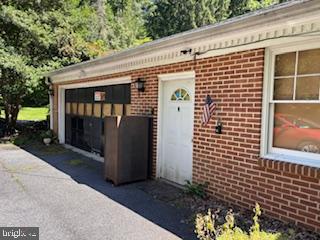 This is the perfect rural retreat! Large ranch style house on 1.5 acre lot with adjoining 6 acre lot included in sale. Lots of privacy and tall trees. Four bedrooms and three full baths, 1 half bath, additional den and /or hobby room. Lower Level partially finished. On the main level there is a Large Country Kitchen, Living Room, Dining Room and huge Family or Rec Room. Behind the house is a pass through garage and then behind that is a huge building that can be used as a garage or mechanics' workspace. It has a separate septic system and well. There is also an in ground pool with cover.