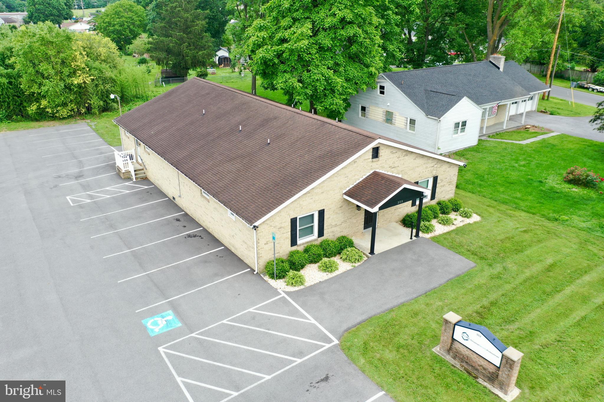 TURNKEY COMMERCIAL OFFICE OPPORTUNITY IN MEDICAL CORRIDOR
Welcome to 302 Rock Cliff Drive — a fully renovated, modern commercial office building in the heart of Martinsburg’s thriving medical corridor. Just minutes from I-81, WVU's Berkeley Medical Center, and this prime location offers unbeatable access and visibility for your business.
In 2022, the current owner took the property down to the studs and transformed it from top to bottom. Major upgrades include:
All-new drywall, electrical, and flooring
Three brand-new HVAC systems with all-new ductwork
Updated to meet current fire code
Repaved parking lot and fresh landscaping
New front windows and entry door
Updated security system and added fiber internet
Stylish modern finishes throughout
The interior layout offers maximum versatility, with 11 individual offices, a conference room, two restrooms, and a kitchenette, making it ideal for professional services, co-working, or administrative operations.
Previously used as a medical office, the infrastructure remains in place for a potential return to medical use — water lines behind the office walls are still present and capped, allowing for easy reconversion to exam rooms or treatment areas.
Whether you're looking for a sleek office HQ, a shared workspace, or a medical suite, 302 Rock Cliff Dr. offers the layout, location, and updates to make it happen.