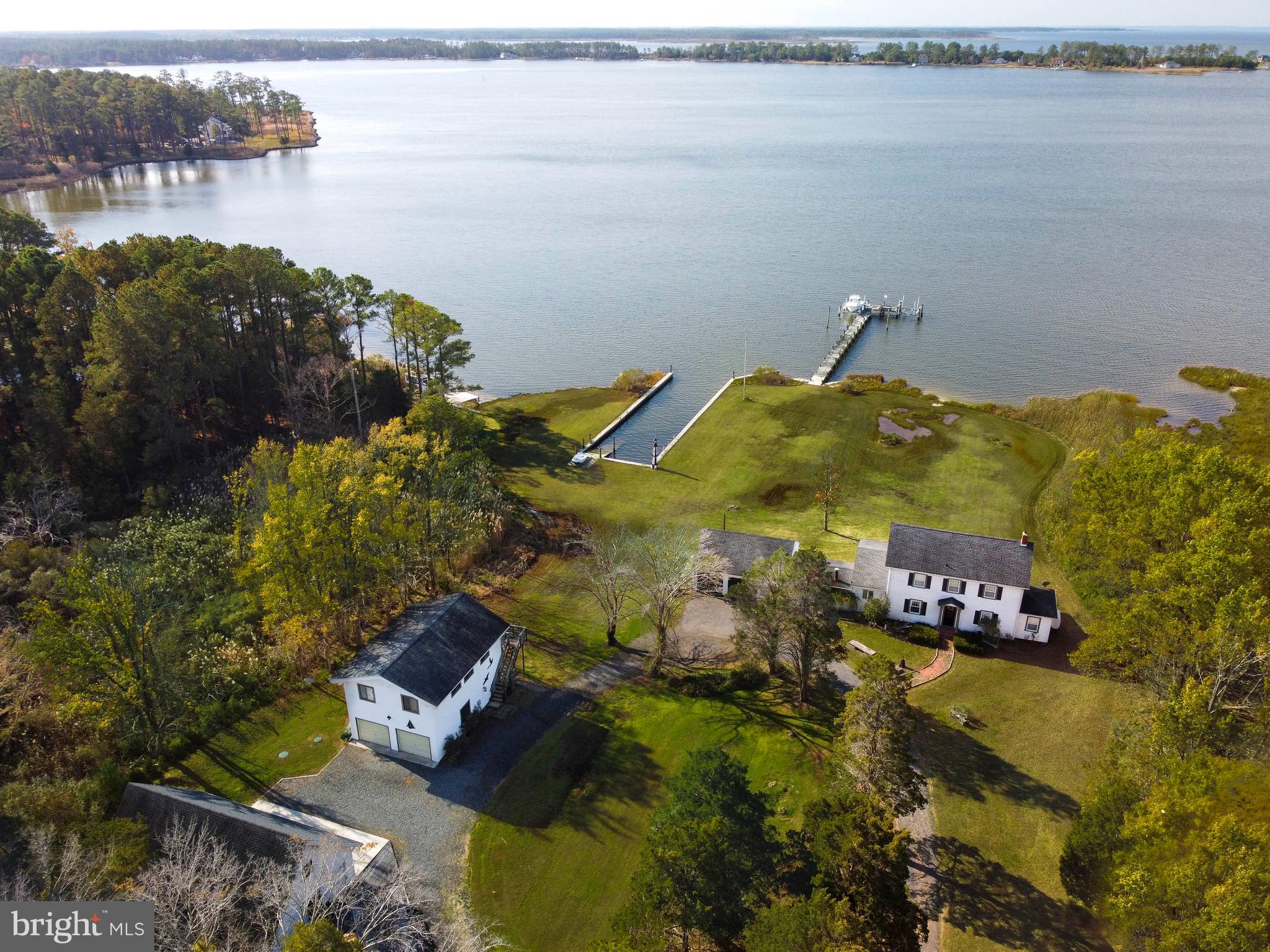 Classic Historic Tidewater Colonial with 525+/- feet on the banks of Fishing Creek overlooking the Little Choptank River with a short ride to the Chesapeake Bay. Close to some of the best fishing spots on the Bay. This Historic Tidewater Colonial w/two bedrooms, living room, den, family room, dining room, kitchen, scenic three season porch, utility room, and two car garage make the Bay and its tributaries a wonderful playground for anyone interested in living on Maryland's Eastern Shore. The property also consists of a guest house with two bedrooms, bath, living room and workshop on the first floor with roll-up doors for easy access, as well as, along with a separate expansive two car garage with bathroom, office and Japanese cultural meditation room on the second floor. A separate Japanese tea room is available for those that want to embrace the Japanese culture. As you venture out to the waterfront, you will find a newly riprapped shoreline with lengthy pier with two boat lifts, and a protected boat basin for kayak and small boat launching. Come enjoy everything living on Maryland's Eastern Shore has to offer. Hot Tub Sold "As-Is"