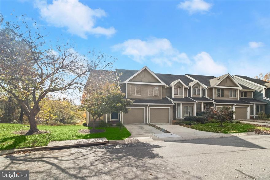 Beautifully appointed end-of-row townhome nestled in a sought-after Columbia community, offering peaceful golf course vistas and a stunning tree-lined backdrop. Hardwood flooring welcomes you into the foyer and flows seamlessly through the elegant living and dining rooms, where expansive sliding doors invite natural light and open to an oversized deck, perfect for morning coffee or evening entertaining while enjoying serene wooded views.  The kitchen is both stylish and functional, featuring warm wood cabinetry, stainless steel appliances, striking black granite countertops and coordinating backsplash, and a charming breakfast room wrapped in windows overlooking the lush landscape.  Upstairs, retreat to the impressive primary bedroom suite with a dramatic vaulted ceiling and a private en suite bath complete with a relaxing soaking tub and extended vanity. Two additional bedrooms, each enhanced by vaulted ceilings, share a well-appointed hall bathroom, creating comfortable and inviting spaces for family or guests.  The finished walk-out lower level expands the living space with a spacious family room centered around a cozy wood-burning fireplace and sliding door access to the patio and backyard, ideal for indoor-outdoor living. A finished flex room offers versatility for a home office, gym, or guest space, complemented by a powder room and a generous storage room. Updated HVAC adds peace of mind.  Backing to tranquil woods and boasting breathtaking views from the expansive deck, this exceptional home combines privacy, beauty, and convenience, all just minutes from major commuter routes, premier shopping, dining, and entertainment.