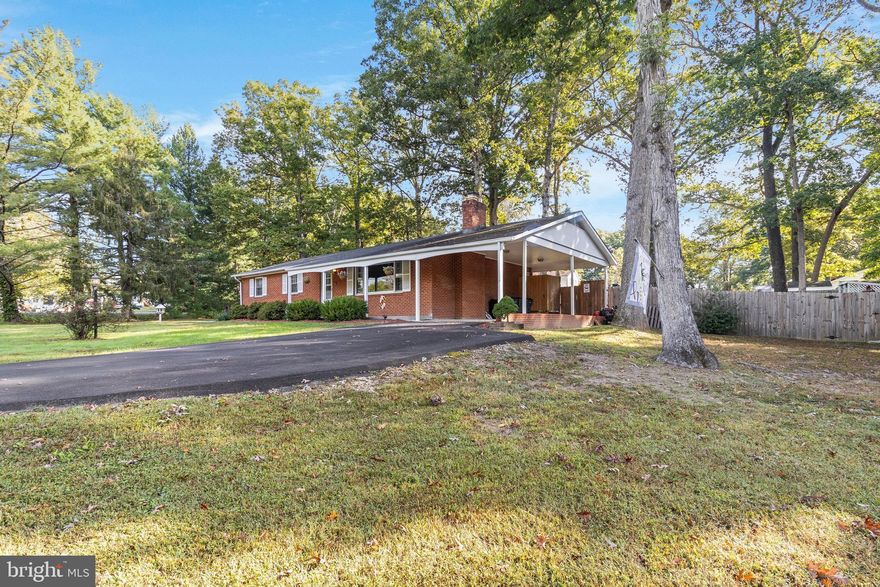Discover your ideal home in Northern Calvert County, just off Brickhouse Road. This inviting brick rambler, nestled on a generous corner lot, offers a range of features and upgrades that set it apart.

Situated on a spacious corner lot, this home provides ample outdoor space for your family to enjoy. Protect your vehicle with the convenient 1-car carport. The backyard is a private retreat with a complete fence, two serene koi ponds, and a tiki-style party bar and dining area. Recent improvements include a new asphalt driveway and a recently updated roof.

Inside, the main level features elegant hardwood flooring throughout, creating a warm and welcoming atmosphere. Gather around the masonry wood fireplace in the living area for cozy evenings. Large windows flood the living spaces with natural light, enhancing the overall charm. The modern, renovated kitchen boasts stainless steel appliances, stone backsplashes, and ceramic flooring. The master bathroom has been thoughtfully updated to meet contemporary design standards. Enjoy personalized comfort in every room with mini-split heating and air conditioning systems.

The full, unfinished basement is a versatile space awaiting your personal touch, whether you envision a recreation area, home gym, or additional living space. The existing bar setup is perfect for hosting gatherings and entertaining friends and family.

This location offers the convenience of being close to shopping and parks, making this property ideal for those seeking both accessibility and recreational opportunities. Secure your dream home in Calvert County today!"