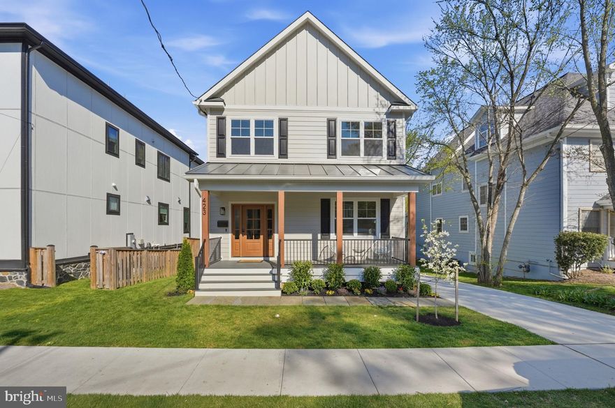 A rare offering in the heart of Arlington, this fully renovated and expanded 5-bedroom, 5-bath residence seamlessly blends sophisticated design with exceptional indoor-outdoor living—just moments from Clarendon’s vibrant dining, shopping, and Metro access, and a short commute into Washington, DC.

From the moment you arrive, the home makes a striking impression with its Trex front porch framed by cedar plank posts—an inviting space to unwind. Inside, expansive windows flood the home with natural light, accentuating the open sightlines and thoughtfully curated finishes throughout the main level. Wide-plank hardwood floors, recessed lighting, and custom trim details set the tone for modern luxury.

At the center of the home is a showstopping chef’s kitchen, outfitted with Café white appliances, a gas range, wine refrigerator, quartz countertops, custom soft-close cabinetry, a walk-in pantry, and an oversized island designed for both everyday living and effortless entertaining. The open-concept layout flows seamlessly into the dining and living areas, while a main-level bedroom and full bath offer flexible living options.

Upstairs, the expansive primary suite serves as a private retreat overlooking the backyard, complete with a generous walk-in closet and a spa-inspired bath featuring a soaking tub and oversized walk-in shower. Two additional bedrooms each offer en-suite baths, and a conveniently located laundry room enhances everyday ease.

The fully finished lower level provides exceptional additional living space—perfect for movie nights, recreation, or hosting guests—with a spacious lounge area, wet bar, a bedroom, and a full bath.

What truly sets this home apart is the flat, private backyard—a rare find in this prime location—offering abundant space to entertain, garden, play, or dine al fresco under the stars.

Every detail has been thoughtfully updated for modern living, including a new roof, siding, windows, two HVAC systems, tankless water heater, driveway, and more—delivering both luxury and peace of mind.

This is a turnkey opportunity to own a beautifully finished home with generous space—inside and out—in one of Arlington’s most sought-after, walkable neighborhoods.