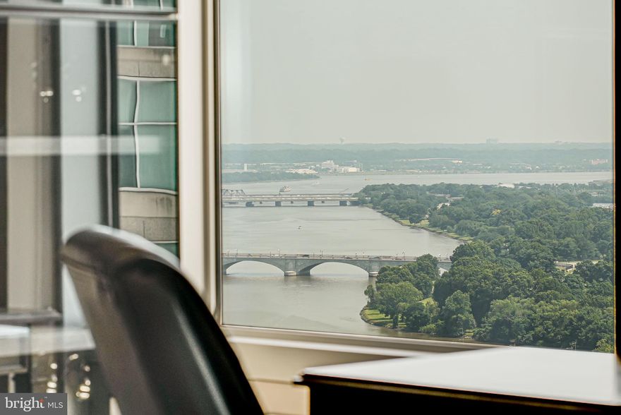 Perched on the 27th floor of The Waterview, The Waterview Lookout offers breathtaking, unobstructed views of the Potomac River and DC’s most iconic landmarks—including the Washington Monument, Jefferson Memorial, and Kennedy Center—all visible from every room. This rarely available 2-bedroom, 2.5-bath residence spans nearly 1,500 sq ft of modern, sun-drenched living space with floor-to-ceiling windows and a seamless open layout.

The kitchen is outfitted with high-end appliances including a Sub-Zero refrigerator, Viking range, and Miele dishwasher. Both bedrooms feature custom-built walk-in closets, and the second bedroom doubles as a flexible guest space or home office with a built-in Murphy bed and shelving system. Additional upgrades include new hardwood flooring throughout, designer lighting, and a recently replaced HVAC system. Two reserved garage parking spaces convey.

Residents of The Waterview enjoy white-glove service with 24/7 concierge, a state-of-the-art fitness center, library, conference room, and an exclusive rooftop terrace offering one of the most striking panoramic views in the entire region—a daily reminder of DC’s beauty and historic charm. Room service is also available from the Le Meridien Hotel, allowing guests to stay and dine without ever leaving the building.  Residents receive a 20% discount on meals at the restaurant.

All of this is just one block from the Rosslyn Metro and moments to Georgetown, downtown DC, and major commuter routes. The Waterview Lookout isn’t just a home—it’s an elevated lifestyle in one of Arlington’s premier full-service buildings.