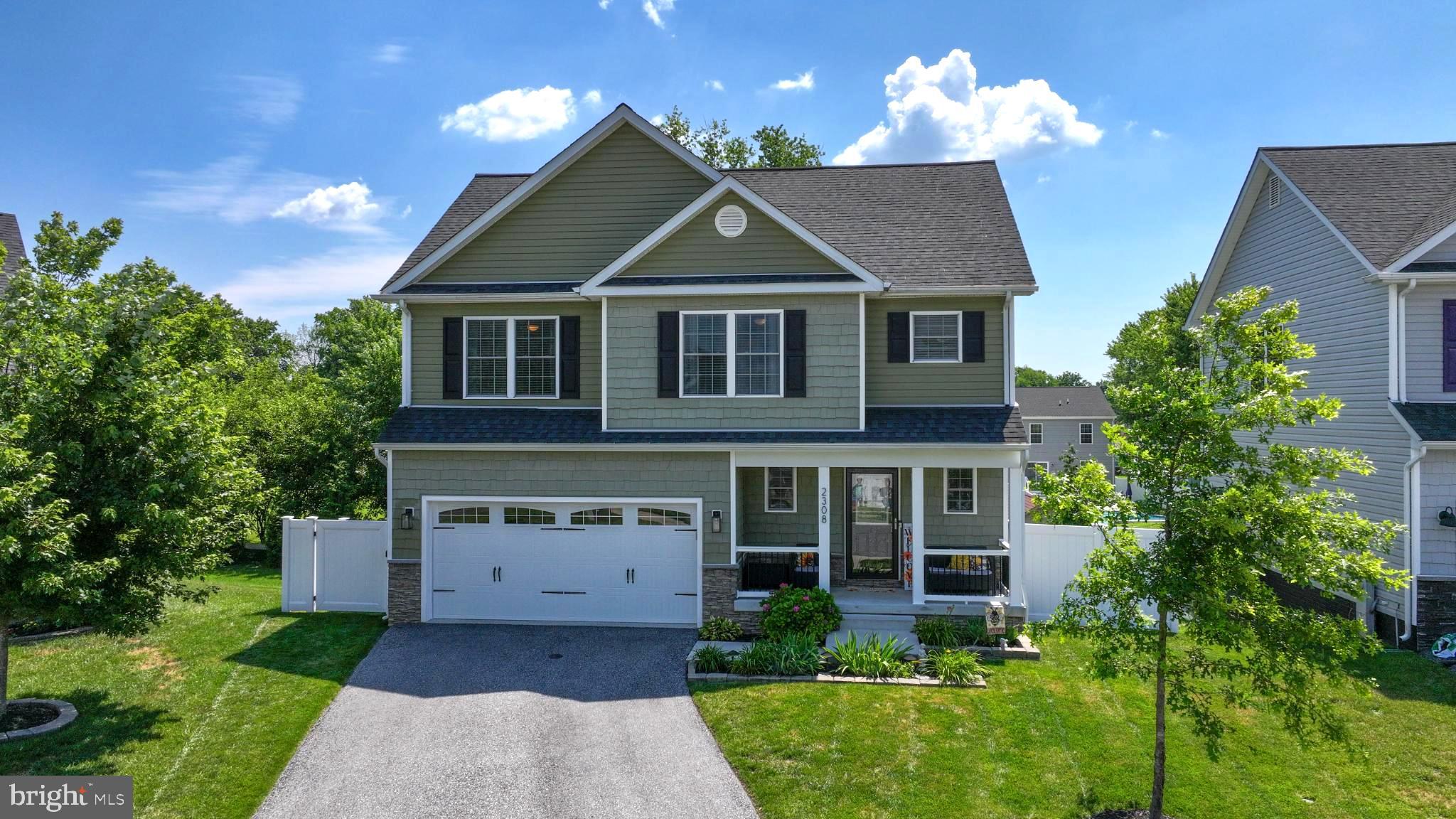 Price Improvement! Welcome to 2308 Estate Avenue! This immaculate 4 bedroom, 3 1/2 bath home looks like it is brand new! Located in Sparrows Point, just minutes from Amazon, FedEx, McCormick, and more, this well maintained home has great curb appeal. The classic green siding, black shutters, and black spindles on the railing, make this house feel like a home where the front porch is the perfect place to take a break. Step inside the front door and you will see the beautiful, engineered hardwood flooring throughout the open living room, dining room and sunroom. The living room has a wood burning fireplace with room for a TV above the mantle. The sunroom is currently used as the main dining space, allowing for more open space between the kitchen and living room, making it perfect for entertaining or everyday living. The half bath sits just off the foyer, so your guests don't have to go upstairs or downstairs. The kitchen features modern, white cabinets with glass panels and lighting in the corner cabinets. The granite countertop has a step-up bar for counter seating, farm sink with an upgraded black faucet, stainless steel appliances, a built-in microwave, and a pantry. There’s plenty of space for a large dining table, and the open layout is perfect for entertaining. Enjoy outdoor living on the expansive deck just off the kitchen—perfect for cookouts and relaxing evenings. Upstairs, you will find 4 spacious bedrooms, including a primary suite with a spa-like en suite bath—featuring a large walk-in shower with a rain showerhead, beautiful upgraded ceramic tile, a large bench seat, and a double vanity. The oversized walk-in closet is perfect for all of your seasonal clothes. The upper level also includes another full bathroom with another tub/shower and a separate laundry room for added convenience. One bedroom is currently used as the home office. The attic access on the upper level has pull down stairs and plywood flooring for additional storage. The large, fully-finished, walk-out basement is currently set up as a game room/playroom, complete with a full bathroom with a tub/shower. The lower level is ideal for an in-law suite, guest retreat, or extra living space. Sliding doors lead to a gorgeous paver patio and a fully fenced backyard with a new, white vinyl, privacy fence with plenty of room to play, entertain, or enjoy outdoor games. The two-car garage features epoxy-coated floors, built-in cabinets, a workbench, suspended ceiling storage and a garage door opener. There is even off-street parking for 4 vehicles in the driveway. The shed provides extra room for your lawn mower and your lawn and garden supplies. This home is situated on a sidewalk-lined community, just minutes from 695. With tasteful décor, a functional layout, and premium finishes throughout, this home is truly move-in ready. Don’t miss your chance to live in one of Baltimore County’s most up-and-coming areas!