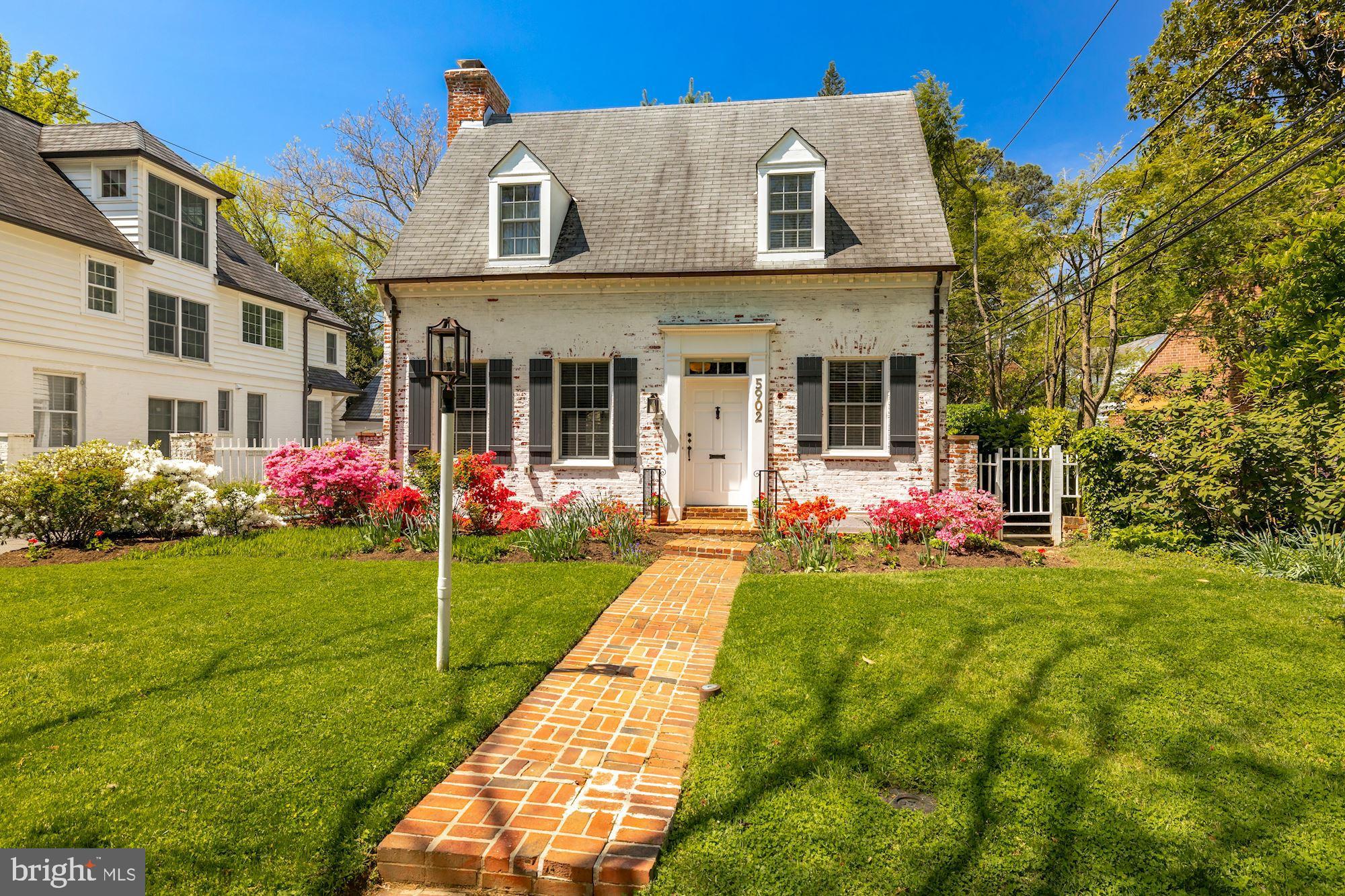 This spacious Cape Cod shines with smart renovations and historic charm! Over 2,100 SF of living space includes a sun-filled living room with fireplace, stunningly updated kitchen with stainless steel appliances, and a formal dining room with bay window, which opens to a covered porch, all on the main level. The upper level consists of an owner's bedroom with en suite renovated full bath, two closets and a dressing room/office overlooking the backyard, two additional bedrooms with ample closet space and a renovated hallway full bath.  The bright lower level contains a family room with fireplace, large storage area and finished laundry room. The covered porch and private backyard are surrounded by mature trees and low-maintenance landscaping. A flagstone patio leads to a convenient, detached one-car garage. This charming home sits on a lovely flat lot on a quiet street in coveted Chevy Chase Village. The amazing location provides walkable access to parks, upscale shopping and dining and the Friendship Heights Metro. A quick drive to Bethesda, D.C. and major commuter routes.