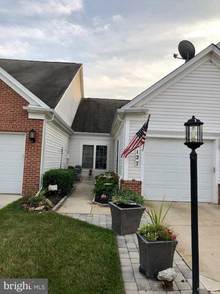 Stunning home, beautifully maintained with gleaming wood floors.Open Floor plan with corian kitchen counters, abundant cabinetry & tile backsplash, 2 generously sized bedrooms, both with plantation shutters & 2 full baths. The bright Sunroom welcomes in the warm sun while a deck with a motorized awning provides shade & privacy when needed. Active adt comm offers lots of amenities incl lawn care!