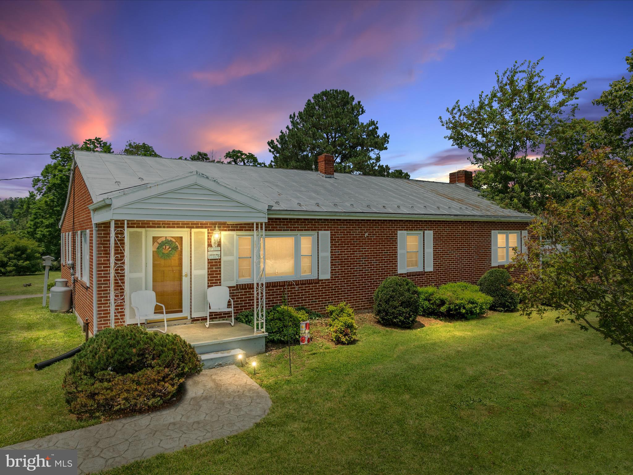 Well-built 1959 all-brick rancher with great potential! This one-level, 3-bedroom, 1-bath home offers 2470 sq ft (including the full unfinished basement) and sits on nearly an acre (.932 acres) of peaceful country land. Features include a metal roof, detached 2-car garage, enclosed back porch with ceramic tile, cabinets, and ceiling fan, plus a front porch perfect for taking in those gorgeous mountain views. Inside you'll find a central vacuum system, family room with a wood-burning fireplace, kitchen with stainless/black appliances, and hardwood floors in the living, dining, and 2 of the bedrooms. The unfinished basement offers laundry, utility sink, shelving, lots of storage and the enclosed back porch offers access to a rear wooden deck.