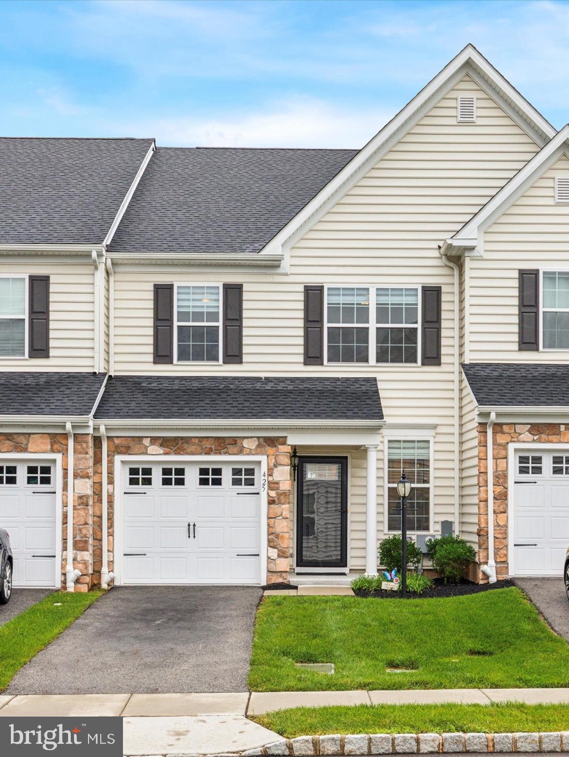 Welcome to 425 Cherry Blossom Lane in the heart of West Norriton’s desirable Reserve at Stoney Creek community. Built in December 2021, this modern townhouse offers a blend of luxury and functionality. With 1,854 square feet of living space, this home features 3 spacious bedrooms and 2.5 baths.
The open-concept living area on the first floor boasts 9-foot ceilings, an electric fireplace, and remote-operated custom linen blinds, as well as hardwood floors. The gourmet kitchen is equipped with a gas stove, granite countertops, a wine rack, and a large 7ft center island—perfect for entertaining. It seamlessly opens to a deck, ideal for outdoor dining and enjoying the fresh air. The primary bedroom is a retreat, complete with a custom walk-in closet and an en suite bathroom including a marble-topped double vanity. Enjoy the spacious upper level laundry room with a sink and the comfort of a Lennox high-efficiency HVAC system and central air conditioning.
Additional highlights include a driveway and attached garage for convenient parking and storage. The grounds include ample guest parking spots for visitors. Located directly across from Norristown Farm Park, enjoy access to 8 miles of walking and biking trails, picnic areas, recreational fishing, with a soon-to-open dog park. Plus, the home is within walking distance to Whitehall Elementary School and Norristown Area High School. Experience comfort and convenience in a vibrant community setting. Come and see this beautiful home today!