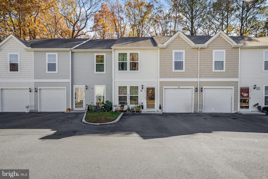Discover this well maintained townhome, showcasing high-end finishes and a prime location with community amenities. Elegant engineered bamboo flooring (a $10,000–$15,000 value) extends throughout. The open-concept main level, features a half bath, living room with dining area, and a family room that opens to the kitchen with granite countertops, island, electric range, built-in microwave, and pantry.
Upstairs includes three Bedrooms—including a spacious Primary Suite with a walk-in closet and full bath, plus a laundry room and additional bathroom. Enjoy peace of mind with a premium high-efficiency furnace (a $10,000 value) under a transferable 10-year warranty. 

Additional highlights include a one-car garage with overhead storage and a private deck backing to trees. Residents enjoy a vibrant lifestyle with access to a Clubhouse, Pool, Cardio Room, Weight Room, and Tot Lot. Perfectly positioned near historic Berlin—“America’s Coolest Small Town”—and just minutes from the Ocean City Boardwalk and Assateague Island, this home blends coastal charm with everyday convenience.