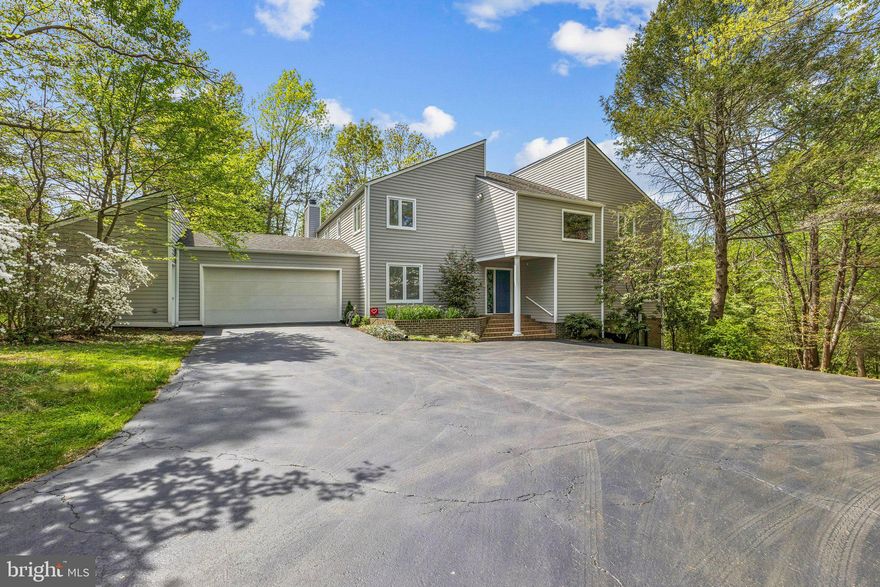 Nestled on 2.5 acres in the sought-after Hunters Valley equestrian community, this exceptional property offers a rare blend of privacy, natural beauty, and convenience. Surrounded by scenic trails and open green space, the setting provides a peaceful, rural atmosphere just minutes from the Town of Vienna and a short drive to Tysons Corner.
With over 4,000 square feet of living space, this contemporary home features 4 bedrooms, including a spacious primary suite with two attached full baths. The open floor plan is highlighted by soaring two-level ceilings, creating an airy, light-filled environment with views overlooking the main living area from the upper level.
The lower-level family room offers an expansive gathering space centered around a cozy fireplace, along with additional room perfect for games, recreation, and entertainment. Outdoors, the wooded lot gently slopes to a tranquil stream, enhancing the home’s serene setting.
A large deck provides the ideal space for outdoor entertainment, offering ultimate privacy and beautiful views of the surrounding landscape. Completing the home is an oversized two-car garage with a dedicated workshop area, perfect for hobbies or projects.
This is a unique opportunity to enjoy spacious living in a picturesque community while remaining close to everything Northern Virginia has to offer.