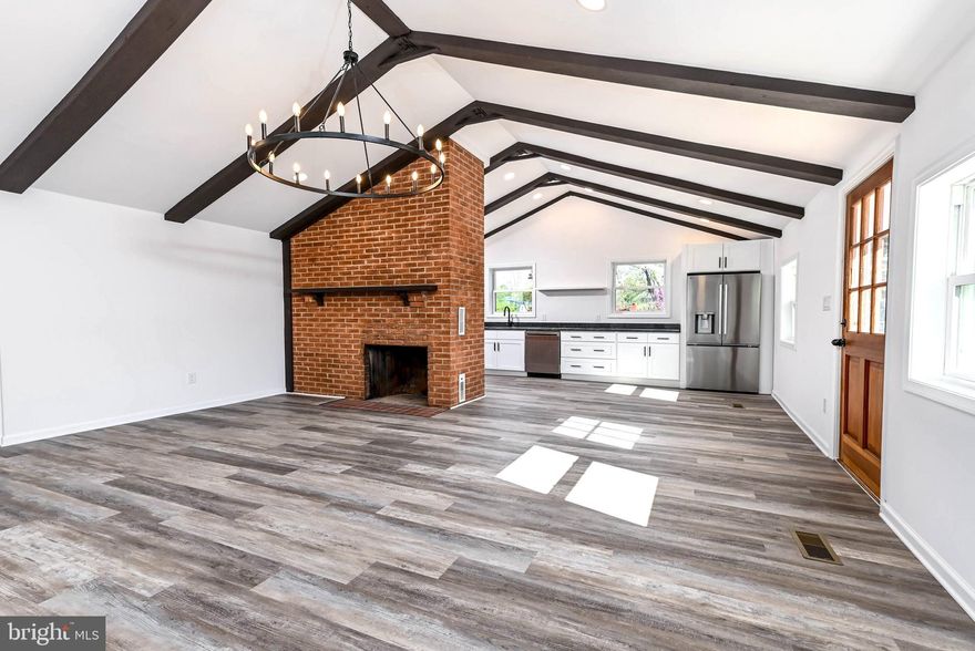 This beautifully remodeled 4-bedroom, 2.5-bath single-family home, set on a generous 0.7-acre lot, offers the perfect blend of peaceful country living with no HOA and easy access to downtown Front Royal, I-66, and Winchester. Completely gutted to the studs and renovated with over $200,000 in upgrades, featuring all-new electrical, plumbing, HVAC, roof, windows, siding, drywall, and flooring for true peace of mind.

The stunning new kitchen showcases stainless steel appliances, shaker-style cabinetry, and granite countertops, opening to a bright living and dining area with eye-catching beamed ceiling and cozy wood-burning fireplace. A spacious family room provides additional living space and direct access to the deck. The owner’s suite offers a private retreat with a full bath, walk-in closet, and a second sliding glass door to the deck. The finished lower level includes a large rec room, half bath, expansive utility/storage area, and an unfinished bonus room ready for your vision. The large back yard if fuly fenced and the front offers plenty of room for parking cars, boats, and RVs.

Enjoy outdoor living at its best with a covered deck, stairs leading to a large fenced yard, and a patio off the rec room—ideal for gatherings or relaxing evenings. Located in the amenity-rich Shenandoah Farms community, residents enjoy access to the Shenandoah River, two private lakes, a recreation center, playground, bike trails, and more.

There is a voluntary property owners association which buyers may opt to join. Recreation decals are available for minimal cost to enjoy neighborhood amenities. This home is located in a Warren County sanitation district which imposes a fee of $175 semi-annually.