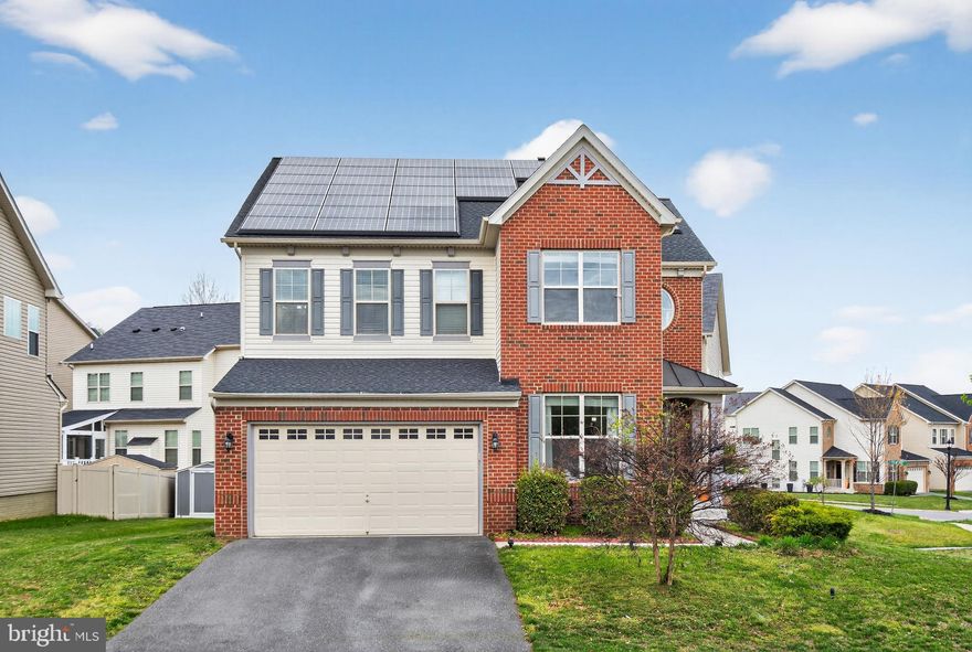 Beautiful contemporary home in a highly coveted Woodmore Towne Centre  directly across from the community club house, tennis and pool. This light-filled home features an open floor plan with high ceilings, dramatic columns, hardwood floors, fireplace, and a screened-in porch. The kitchen offers granite countertops, gas cooktop, double ovens, built-in microwave, and a designer tile backsplash. Main-level office and upper-level laundry add everyday convenience, while appealing wall colors enhance the modern feel.  The fully permitted lower-level unit generates $1,700/month with a month-to-month tenant—ideal for income or flexible living.
Solar panels in place (approx. $18,000 lease balance).Convenient to shopping, dining, and Metro! Subject to third-party court approval (not a short sale) with ratification occurring when presented/accepted and court approval within 21 days.