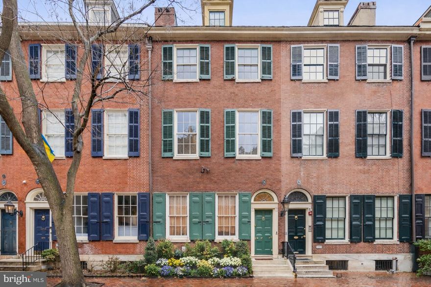 Built in 1836, 1017 Clinton sits on one of Washington Square West’s most picturesque, tree-lined blocks. This stately 20-foot-wide residence extends 100 feet deep to Cypress Street, where neighboring properties have transformed their garden spaces into private parking.

Rich in historic charm and original detail, the home showcases soaring ceilings, beautiful hardwood floors, three wood-burning fireplaces, intricate period moldings, and timeless architectural character throughout.

A welcoming entrance leads into a gracious main hallway, opening to expansive living and dining rooms—ideal for both everyday living and elegant entertaining. Continuing down the hall, you’ll find a convenient half bath before arriving at the heart of the home: a bright, chef’s eat-in kitchen wrapped in windows. Outfitted with a Sub-Zero refrigerator, Wolf six burner cooktop with infrared grill, two Wolf wall ovens, generous center island, and serene views of the wraparound garden, this space blends function and beauty seamlessly.

The upper level features a private au pair suite complete with its own kitchen and full bath. Above, the primary suite is joined by four additional bedrooms and two full baths, offering flexibility for family, guests, or home office needs.

The partially finished lower level includes a laundry room and exercise area provides abundant storage and utility space, including a dedicated temperature-controlled wine cellar and multiple work areas—ready to be customized to suit your vision. There is also an attic with two dormer rooms.

A rare opportunity to own a grand, historically rich home in one of the city’s most desirable neighborhoods.