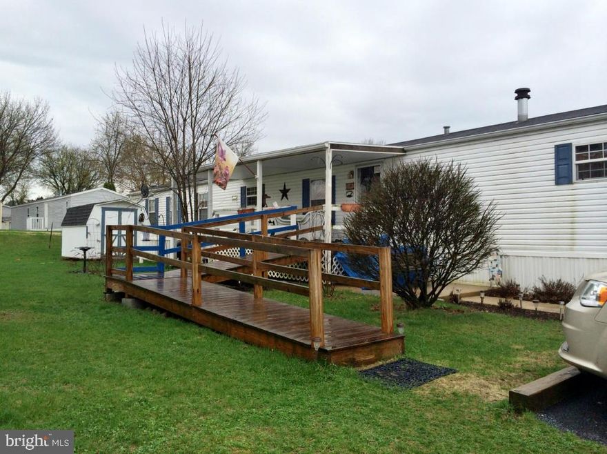 OVER 55 Community, enjoy quiet retirement living in this COUNTRY COZY singlewide. 2000 Champion (by Liberty) 16x76 with ramp access and covered porch. AVAILABLE FOR SEPT 1 OCCUPANCY. Stained glass & tiffany lighting fixtures are reserved by Seller. Wood shutters in kitchen stay. Water softener stays. Equipped with heat detector/smoke alarms and 6 ceiling fans! See 31 pics. Small dogs OK.