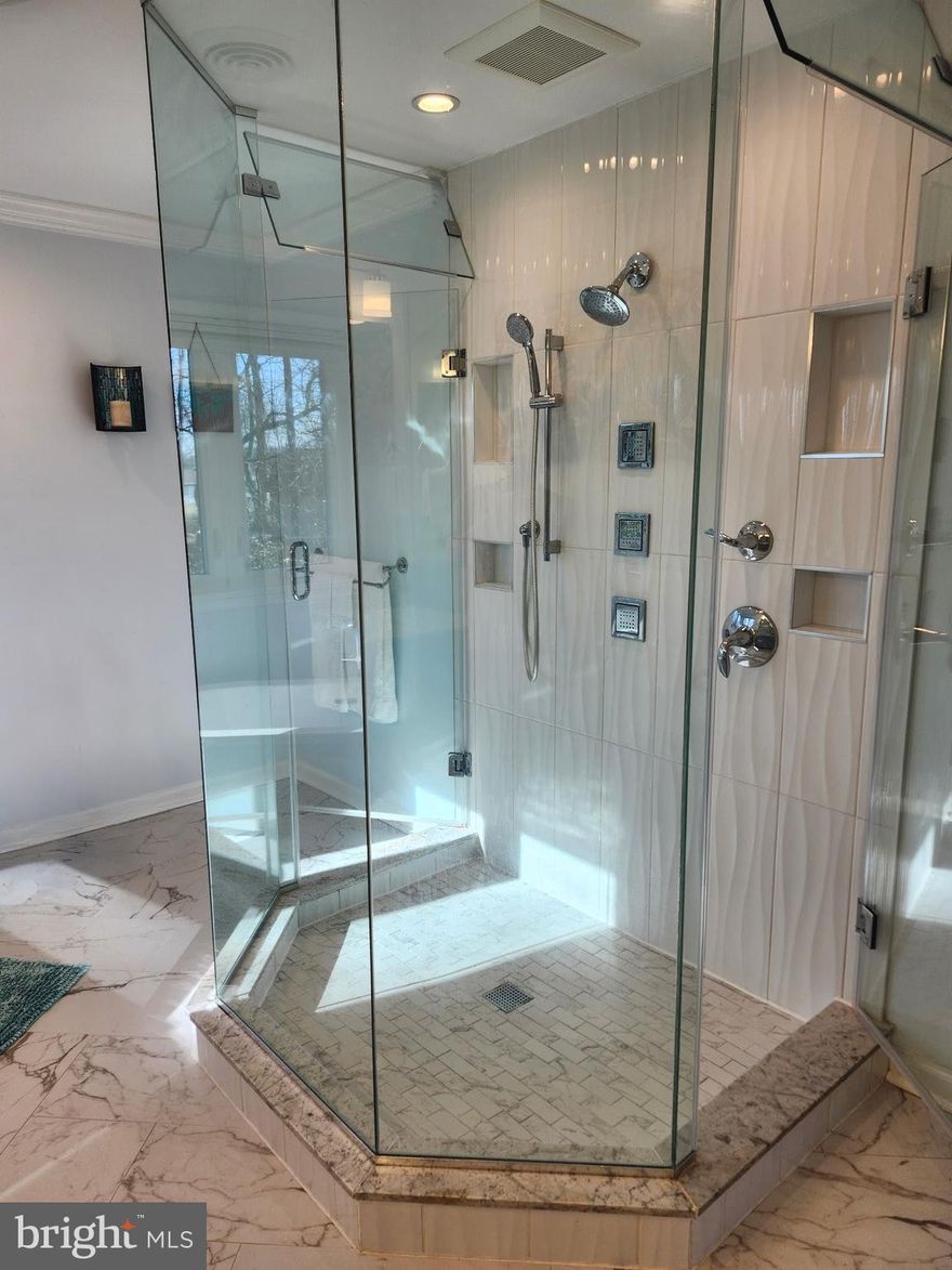 All brick colonial on a very private, wooded 2.5 acre lot in Bradford Estates with NO HOA!! Start to unwind as you head down the long, peaceful driveway that is tucked away from neighbors and surrounded by wildlife.  Upon entry, you will be greeted with a two-story foyer, beautiful wooden staircase, rich solid wood colonial style doors and hardwood floors that span the entire main level. The kitchen has an attached breakfast nook and features granite countertops, stainless steel appliances and a center island induction cooktop with overhead stainless steel exhaust fan. The family room opens onto an expansive deck with an attached gazebo, which is the perfect spot to sit and enjoy the peaceful setting and decompress with a cup of coffee or evening cocktail. However, the privacy doesn’t end in the backyard; each bedroom has its own private bathroom. The updated primary bath includes a soaking tub and luxurious walk-in shower. The finished walk-out basement includes a kitchenette, family room and bedroom with ensuite. The side-load 2 car garage has built-in workbenches and a huge walk-up storage loft. A large detached shed provides even more storage. Additional home features include an energy efficient geothermal dual zone  HVAC system, a tankless hot water heater, a whole house water filter and water softener system.  The roof is approx. 7 years old with new gutters installed in 2024. 
Enjoy the best of both worlds- your own private retreat, yet mere minutes from a vast amount of local amenities and major commuter routes.