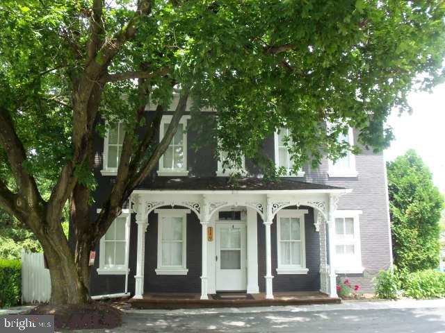 Live and Love! You could easily live in this house as it stands but adding loving touches, fresh paint and some updates would make it amazing! Bedrooms have 10 foot ceilings, big windows and hardwood floors. Uncover the hardwood floors downstairs in the large living room and formal dining room. Laundry and utility room is on the main floor right off the half bath. Pantry with built in shelves and a big kitchen. Large level yard with a small barn would make a great workshop or garage. Picture perfect front porch and a covered back porch too!