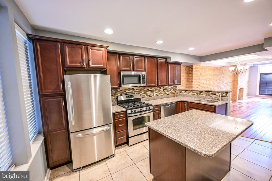Welcome to this fantastic 3-bedroom, 3-bathroom home with private parking and a rooftop deck, perfectly situated just half a block north of Patterson Park! 

Natural light pours into the spacious living room through two oversized front windows adorned with charming louvered shutters. The open dining area easily accommodates a table for six, leading into a beautifully appointed gourmet kitchen featuring granite countertops, stainless steel appliances, and ample cabinet and counter space. A rear door off the kitchen offers convenient access to the private parking pad and stairs to a multi-level deck—culminating in a stunning rooftop retreat.

Upstairs, the second level hosts a serene primary suite with an en-suite bath boasting a large tiled shower. A second bedroom is located at the opposite end of the hall, adjacent to a full bathroom with a tub/shower combination.

The fully finished lower level includes a third bedroom and an additional full bathroom—perfect for guests or a home office. There is also a recreation room with wet bar and wine fridge. This level also offers walkout access to the rear parking pad via stairs though a secured door.
