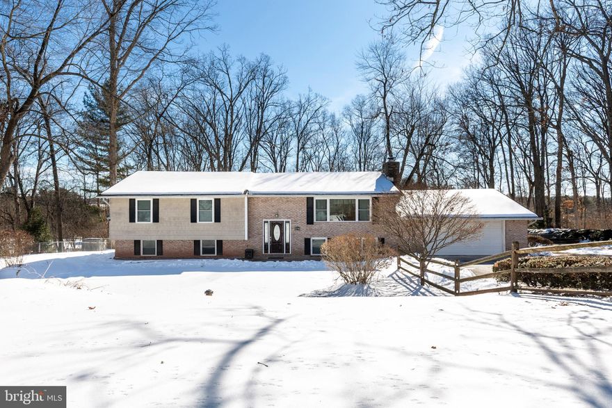 Nestled on a private .86-acre lot in a peaceful rural setting surrounded by mature trees, this beautifully maintained split foyer offers space, comfort, and thoughtful upgrades throughout. Featuring 5 bedrooms and 3 full bathrooms, all baths have been updated and include cozy heated floors. The open foyer welcomes you to the upper-level showcasing hardwood floors, a country kitchen with granite countertops, large island, and custom cabinetry, and a spacious living room with a wood-burning fireplace and bay window. The primary bedroom includes a private bath, plus two additional bedrooms on the main level. The lower level offers two more bedrooms, a full bath, brand-new carpet, and a large family room warmed by a pellet stove with stainless steel liner. Enjoy direct access to the oversized two-car garage with extra storage. Additional highlights include a 2022 deck, fenced yard, back patio with hot tub hookup, replacement windows and doors, outdoor HVAC unit (2024), new hot water heater, reverse osmosis system, and water softener. A perfect blend of rural charm, modern updates, and generous living space—this home is truly move-in ready.