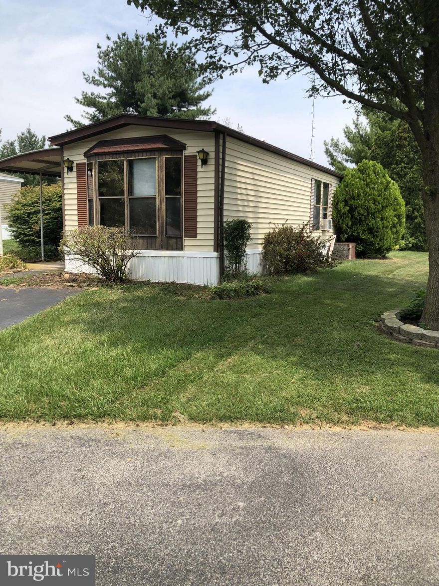 Great opportunity for affordable home ownership and to enjoy the benefits and freedom of choices included.  Split layout of 2 bedrm, 2 ba (1 each located at opposite ends of home) make for ideal privacy and home sharing.  All appliances included. Open layout of common areas with expanded width offers options for furniture placement, entertainment, and flow (1,200 sq ft!). Kitchen counter space, cabinets, and closets are abundant. Dining area has built-ins providing a separate but still open area. Separate laundry room with storage and door to backyard.  Home on level rented lot with greenery for relaxing feel. Enjoy outdoors on the covered porch or in the nice back yard (storage shed included). Some replacement windows.  Replace carpet and do some sweat-equity building repairs and have a solid affordable home.  Have you checked home rental prices lately? If so, you will see the value here. Convenient to schools, grocery, library, park, shopping, entertainment.  Off-street private parking. Lot rent includes water, sewer, trash. Note: Home is 'sold as is'; homeowner unable to make alterations. Buyer must be approved by MHP management. (Pets ok with restrictions/approvals.)