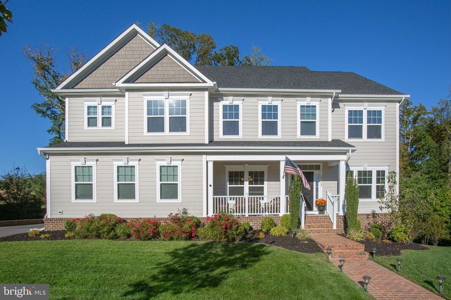 Make yourself at home in this stunning Versailles model that was designed with distinction! Sited on a premium lot, backing the 16th fairway of a Jack Nicklaus Signature Design Golf Course, the home combines classic style with modern design.  Enter onto the gleaming hardwood foyer from the covered front porch and, by day, you are welcomed by warm natural light and a neutral decor that flows throughout.  To your right is the study, which features French doors to maintain distractions at a minimum.  To the left of the foyer, the current owners are using this space as a living rm, where you might prefer to utilize the space as your formal dining rm.  Follow the hardwood foyer and you will discover the 1st floor bedroom and a full hall bath which provides main-level comfort.  Past the foyer, through an arched opening you will be taken in by the 2-story great rm with it's wall of windows and floor to ceiling, stone hearth fireplace.  Off to the right of the fireplace, you will notice a door that leads to a covered rear composite deck where you can enjoy some fresh air and quiet time.  The great room flows into the gourmet kitchen and the dining area, where sliding glass doors lead to a large composite deck overlooking a lush rear lawn.  Adorned by an abundance of gorgeous cherry cabinetry and topped off with granite counters, the kitchen is fully equipped with stainless appliances.  A large island adds workspace for the cook in the house and a breakfast bar to enjoy a meal or just keep the cook company.  To the rear of the kitchen is where you will find the entry from the 2-car side load garage with automatic garage door opener.  This area also provides plenty of space for outdoor clothing and footwear and a pantry closet.  As you make your way up the staircase to the upper level, you cannot help but to admire the magnificence of the great rm where many hours will be spent making cherished memories.  Of course, the upper level features the owner's bedroom and bath suite where you will not be disappointed.  Well placed windows provide lots of natural light to the owner's suite which features a tray ceiling above the bed, a fireplace (electric), and a large sitting area.  The bath suite offers separate vanities, a garden soaking tub, and separate shower.  One of the 3 additional bedrooms on the upper level has it's own private full bath, while a full hall bath serves the other 2 bedrooms.  There is more to the upper level.  There is another rm, which could be the 5th bedroom, but this rm is utilized as a dressing rm and this dressing rm is amazing!  In addition to smartly designed closet organizers, the rm has a private full bath.  The upper level is where the laundry rm is conveniently located.  The lower level of the home features a spacious recreation and family rm with an awesome wet bar.  Additionally, the lower level offers a media room, exercise rm, full hall bath, storage rm, and a level walk-out exit to the rear yard.  There are many other features of the home that a visit will reveal, but to name a few more, there is an underground irrigation system, alarm system, and the home is pre-wired for sound. This home is truly a one-of-a-kind find and what makes this opportunity even more attractive are the exceptional amenities that Potomac Shores has to offer. There are state-of-the-art fitness facilities, outdoor swimming pools, walking trails, a kayak/canoe launch, the Club House with a full kitchen, gym, community garden, tot lots, numerous community events, a Jack Nicklaus Signature Design 18-Hole Golf Course and Tidewater Grill. The Ali Krieger Sports Complex is located within the community, as is Covington-Harper Elementary School, Potomac Shores Middle School, and John Paul The Great Catholic High School.  A Virginia Railway Express station is
scheduled to open in 2022 and a retail Town Center that will be known as The Marketplace and marina are planned.  What more could you ask for in a community that you could call home?