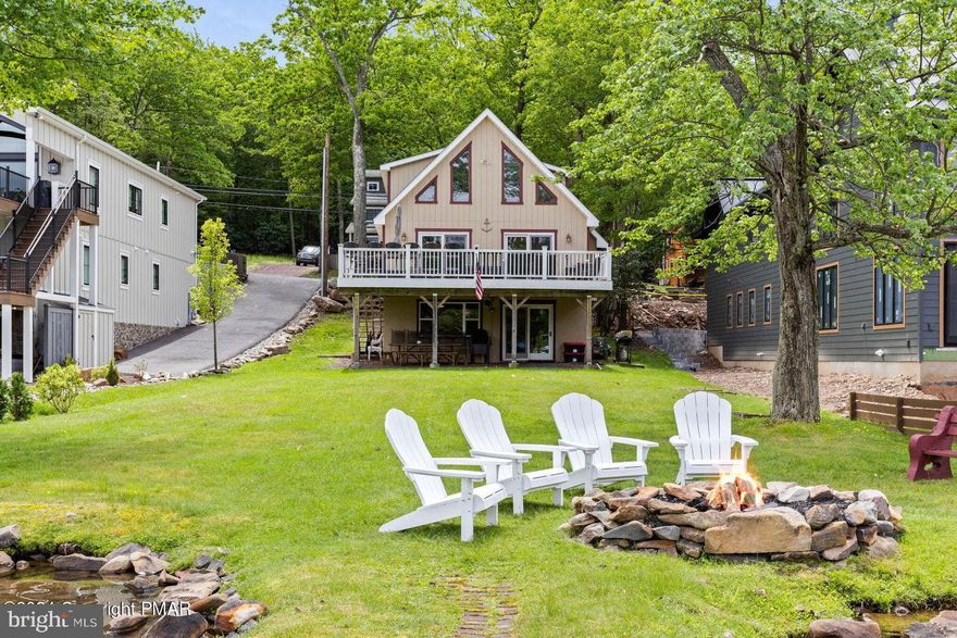 LAKEFRONT home on the shore of shimmering Lake Harmony, this serene haven seamlessly blends with the natural beauty of the lake. Wake up to the gentle sound of lapping waves and in the evening watch picturesque sunsets, by the dock, painting the sky in hues of gold, red & orange. This 4 br, 2 bath meticulously-cared-for retreat boasts windows that invite the outdoors in, allowing you to savor the views of the lake. The expansive deck offers the perfect setting for al fresco dining or simply unwinding while immersed in the tranquility of this lakeside paradise. With its tasteful interior, modern amenities, and private dock, this is not just a home; it's a LIFESTYLE defined by elegance and escapism! Welcome to your own oasis where every day feels like vacation.