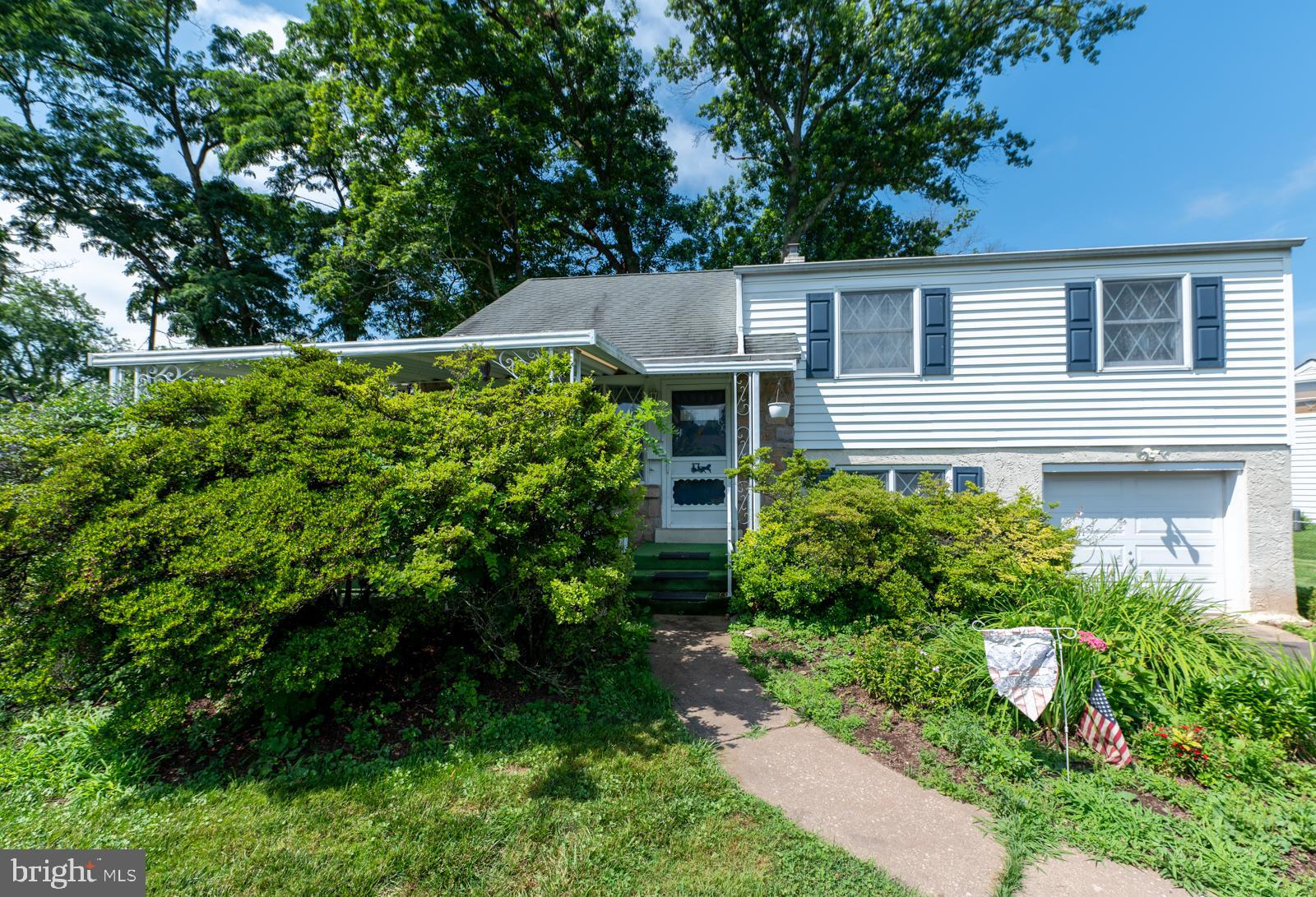 Charming and full of potential, this 3-bedroom, 1.5-bath single-family home is located in the desirable North Penn School District. A welcoming private covered front patio sets the tone—perfect for enjoying your morning coffee. Step inside to a bright, open-concept living and dining area that flows into a cozy kitchen. Upstairs, you'll find three bedrooms and a beautifully renovated hall bath featuring elegant tile flooring, a new vanity, beadboard trim, and a stylish shower/soaking tub combo. Hardwood floors run throughout the second level. A walk-up attic provides excellent potential for a fourth bedroom or bonus living space. Just a half-level down, the inviting family room features charming wood paneling and a built-in bar, plus access to a laundry room with a convenient half bath and walk-out to a smaller rear patio and a spacious, mostly fenced backyard. An oversized one-car garage provides additional storage. Tucked away in a quiet neighborhood yet just minutes from Montgomery Mall, the turnpike, major commuter routes, restaurants, and more. New HVAC system installed in 2024 and fully updated bathroom—move-in ready and waiting for you!