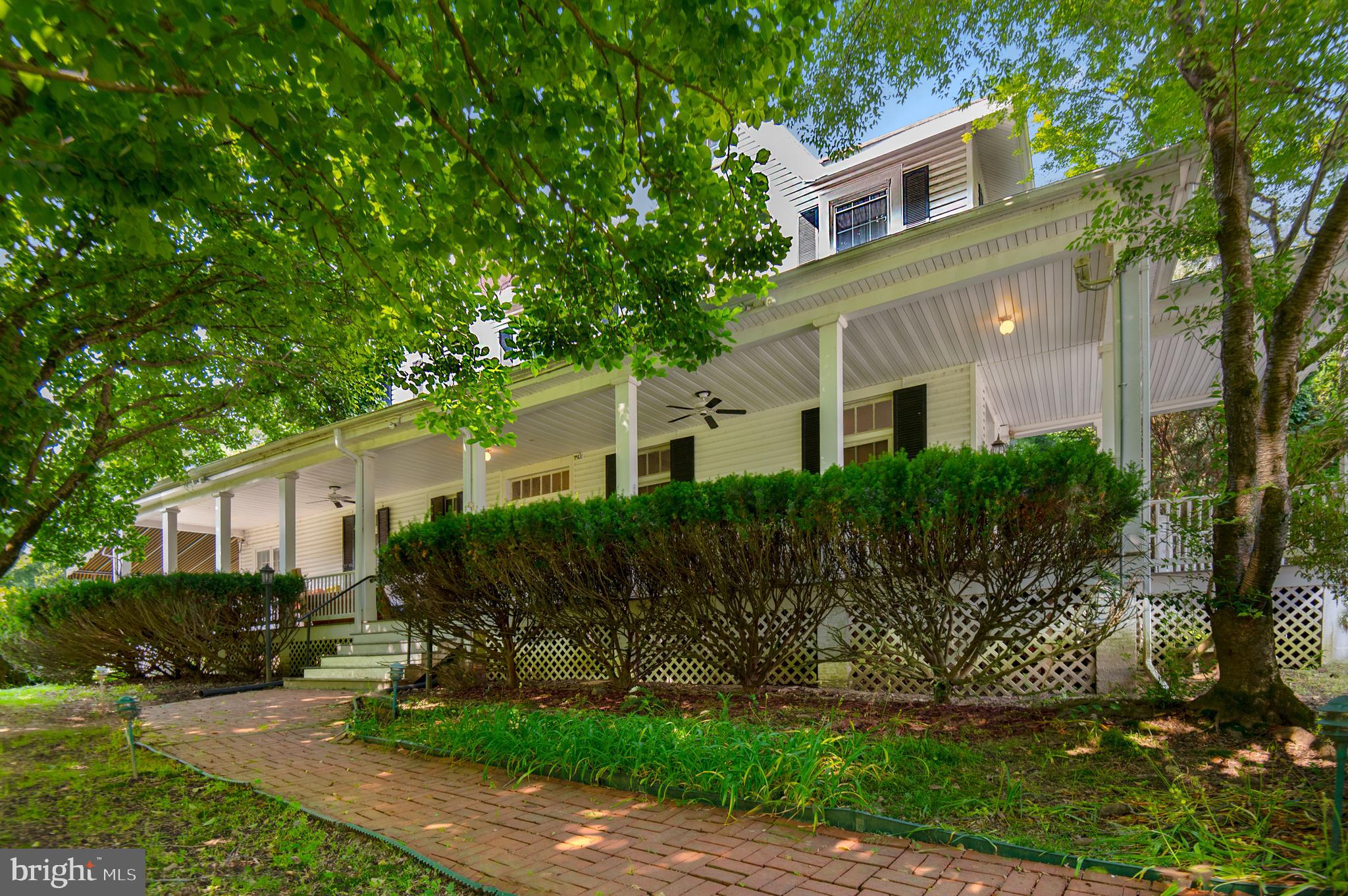 This unique property offers a range of possibilities for investors or for families desiring a premier property at the top of prestigious L'hirondelle Club Road in Ruxton. This approximately 10,000SF home is one of the original properties built in the late 1800's featuring 10-11 foot ceilings, hardwood floors and lots of ornate trim including solid mahogany paneling and granite mantle in the formal dining room. This 1.75 acre property borders dozens of acres of forested, undevelopable land. It also offers the most flat land AND the most parking on L'hirondelle Club Road, making it an excellent choice for entertaining or hosting large family gatherings. This home can be easily customized to be your dream home- you are only limited by your imagination. Just check out the line drawings included in the photos! Excellent opportunity for multi-generational living. In addition, there are TWO detached garages- a 2000SF four car, two story building and a 1000SF one story building that could be easily converted to a workshop or office, or could be used for storage. Mature trees, a 15' X 30' in-ground pool with new filter (2023) and an incredible wrap-around porch complete the dream. Priced well below appraised value, this also represents an outstanding opportunity for investors: ARV should be well over 4M (check the comps), so with even a 1M upgrade the expected net would be well over 1.5M. Hard money financing available!!!! (Trius Lending Partners) , interest only payments, 1 year note, available with 20% down !!!! Must be seen to be appreciated! This is a rare opportunity that has not been on the market in almost 60 years. " Some photos have been digitally altered" Let's Make The Deal!