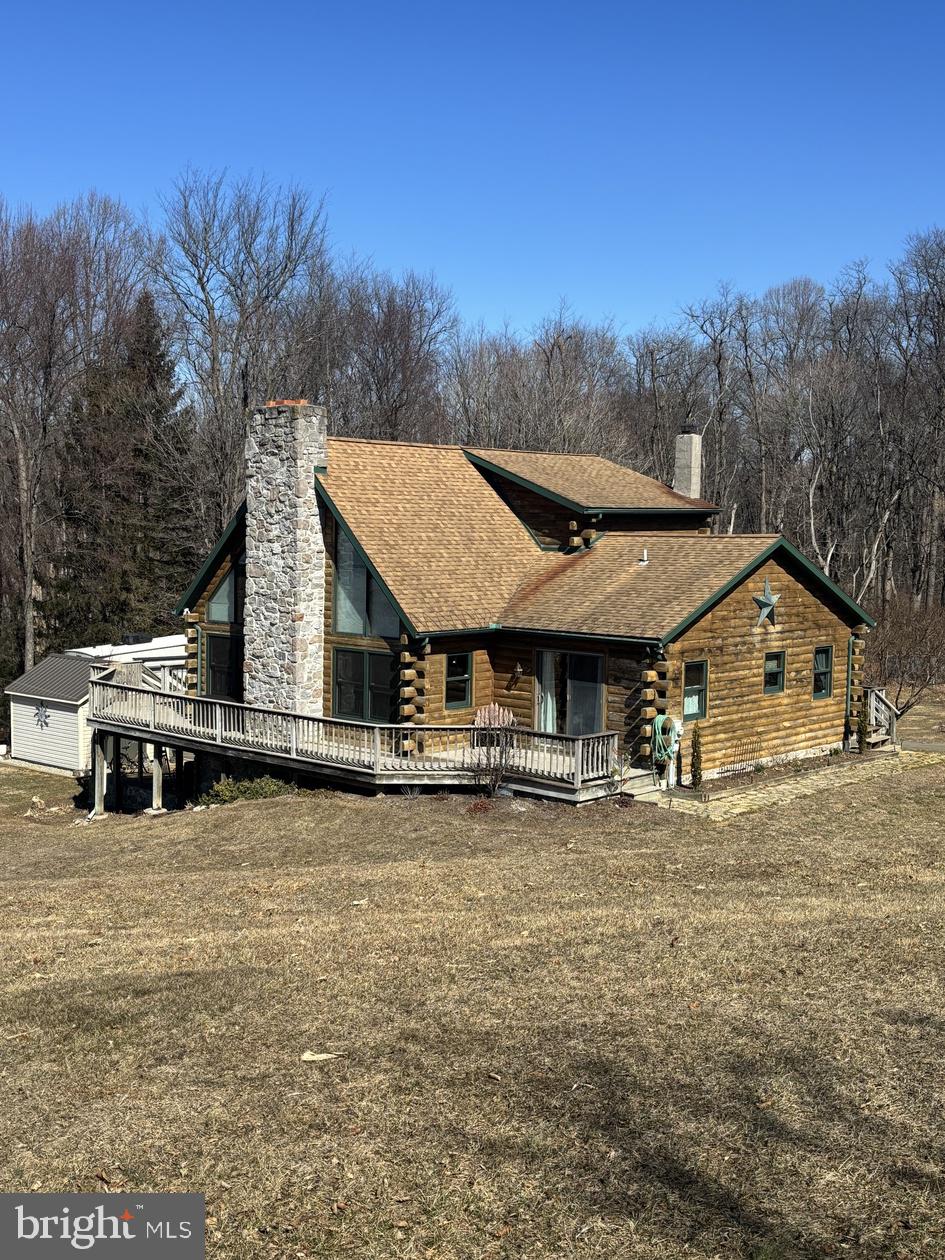 THIS PROPERTY IS GOING TO AUCTION ON SATURDAY JUNE 7, 2025 @ 12:00 NOON. THE LIST PRICE ONLY REFELCTS THE SUGGESTED STARTING BID. Stunning log home built in 2001, nestled in a secluded area on 14 acres, with 11 acres offering tillable opportunities. 1.5 story residence features 3 bedrooms (one with a loft) and 3 full bathrooms. Country-style kitchen and dining area, complemented by painted oak cabinets. Living room showcases a cathedral ceiling and cozy gas/wood fireplace. On the second floor, the primary bedroom suite includes a full bathroom equipped with a whirlpool tub and walk-in shower, walk-in closet, and outside balcony. Full finished basement has a one-car garage, craft/office room, cedar-lined closet, fireproof room, and full bathroom/laundry room. This cozy house has central air, propane/wood forced air furnace, central vaccum, 2-hot water heaters, 200 amp electric service with a breakout box for generator hook-up. Outside enjoy a wrap-around deck complete with a hot tub and grill. Additionally, the property features a 14 x 32 shed and a 12 x 10 shed, surrounded by mature trees and ample acreage. This property is a must see, the possibilities are endless!