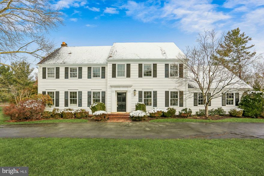 With some of the prettiest curb appeal in the area, this majestic Colonial makes a lasting first impression. Perfectly sited on over two acres in the desirable Spring Meadows neighborhood of Darnestown, the home is introduced by a circular driveway and a commanding yet welcoming presence.

Offering approximately 5,500 square feet across three finished levels, the layout is gracious, thoughtfully designed, and ideal for both everyday living and large-scale entertaining. The main level begins with a formal entry hall flanked by a generously sized formal living room and formal dining room. The dining room can comfortably accommodate an extra-large table, or even two, making it perfect for memorable holiday gatherings, while the living room offers ample space for multiple seating areas, a game table, or a bar setup.

Just off the dining room, the recently renovated kitchen has been updated in a timeless, elegant style. Anchored by a large quartz center island with counter seating, the space also features abundant cabinetry and gourmet appliances. Adjacent to the kitchen, the laundry room and mudroom connect directly to the garage, creating an effortless daily flow and added convenience.

At the rear of the kitchen is a wonderful flexible living space, currently used as a children’s play area and casual family room with room for a kitchen table, easily adaptable to suit your lifestyle. Three walls of windows flood this area with natural light and offer beautiful views of, and direct access to, the expansive backyard. Designed for indoor-outdoor living, the property features a flagstone patio, ideal for entertaining, outdoor dining, and relaxed family grilling nights. This level also includes a newly updated powder room and an additional access door to the rear yard.

Tucked behind the formal living room is yet another inviting family room, which has also served as a library or study. Centered around a gorgeous fireplace and framed by windows overlooking the private grounds, this space provides a cozy and refined retreat.

Upstairs, the primary suite is a true sanctuary, featuring a recently renovated, luxurious bath finished in a classic, timeless design. The bedroom offers abundant closet space and plenty of room for a comfortable reading nook. Three additional generously sized bedrooms complete this level, all with ample closet space and lovely views. The rear bedroom is served by an updated hall bath, while the two front bedrooms share a beautifully updated Jack-and-Jill bath.

The lower level is partially finished and offers outstanding potential to be fully completed into a large great room. The finished portion features high-end luxury vinyl flooring and is ideal as a gym, recreation space, playroom, or teenage hangout.

Recently repainted and completely move-in ready, this classic center hall Colonial offers a rare combination of scale, setting, and timeless appeal. Between the off-the-charts curb appeal, expansive rooms, renovated kitchen and baths, and the exceptional two-acre lot, this home is truly a special opportunity that does not come along often. An added bonus is a fenced portion of the yard, perfect for a garden, dog run, or whatever best suits your needs.